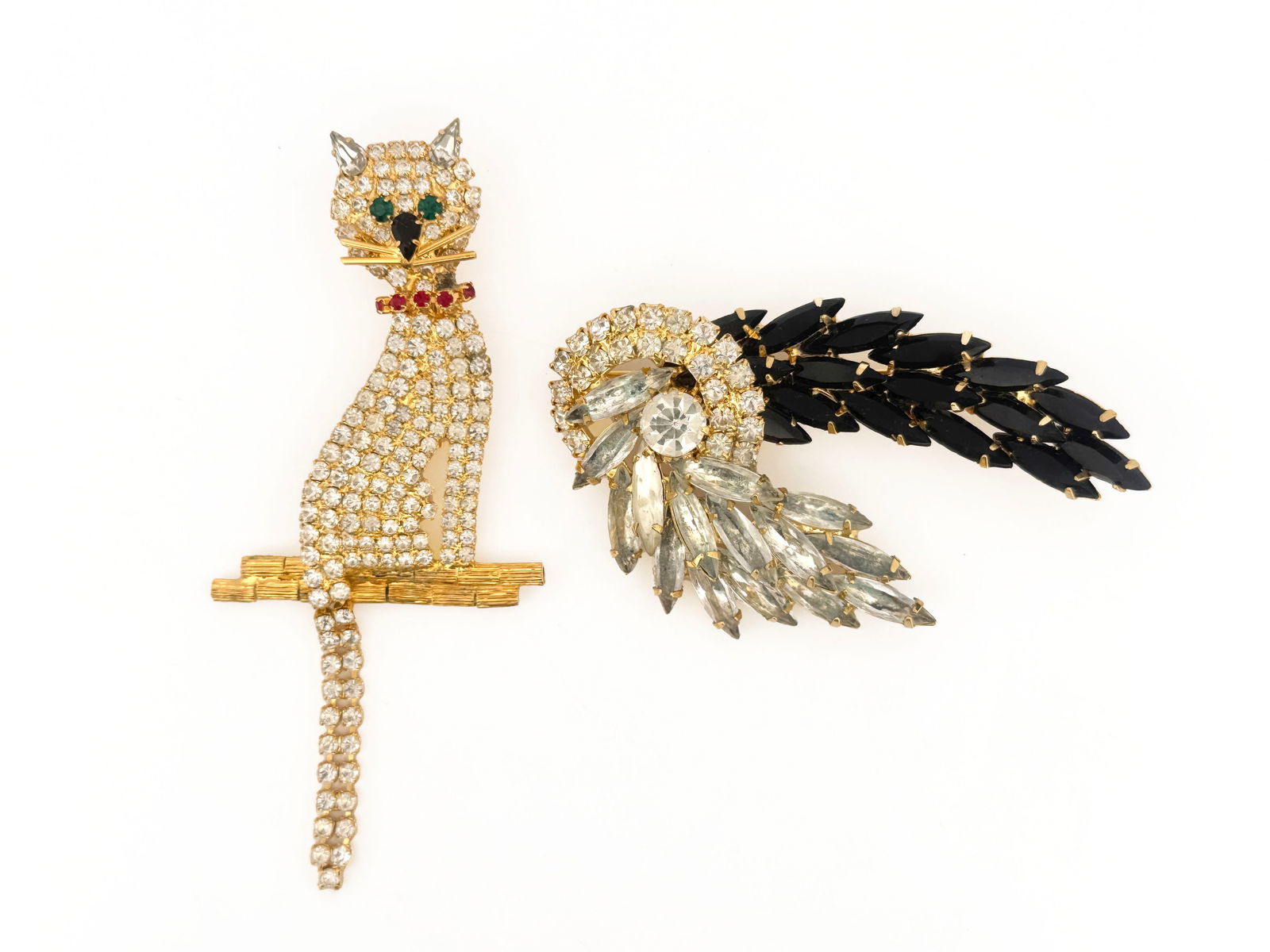 Two Rhinestone Brooches: Two rhinestone brooches, including a cat with an articulated tail.3.75" long34g.