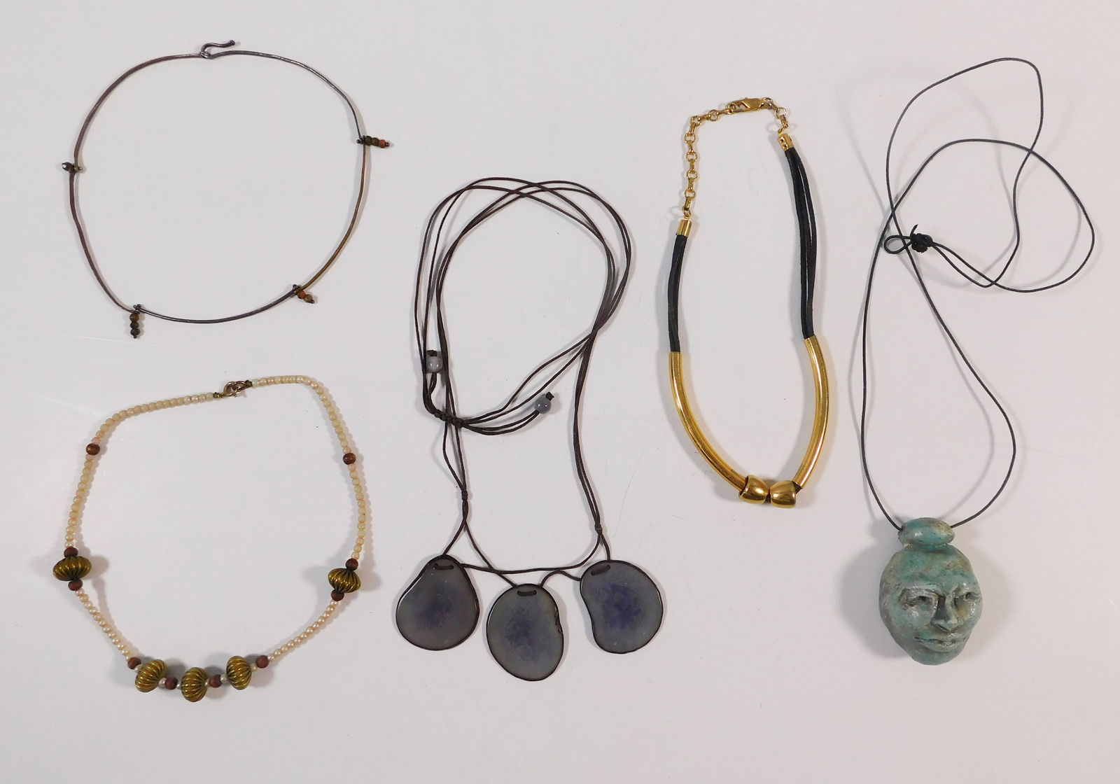 Group of Five Necklaces: This lot features five necklaces of varying styles and materials. Includes necklaces with stone pendants, bead accents, and metal components. The largest necklace measures approximately 18 i