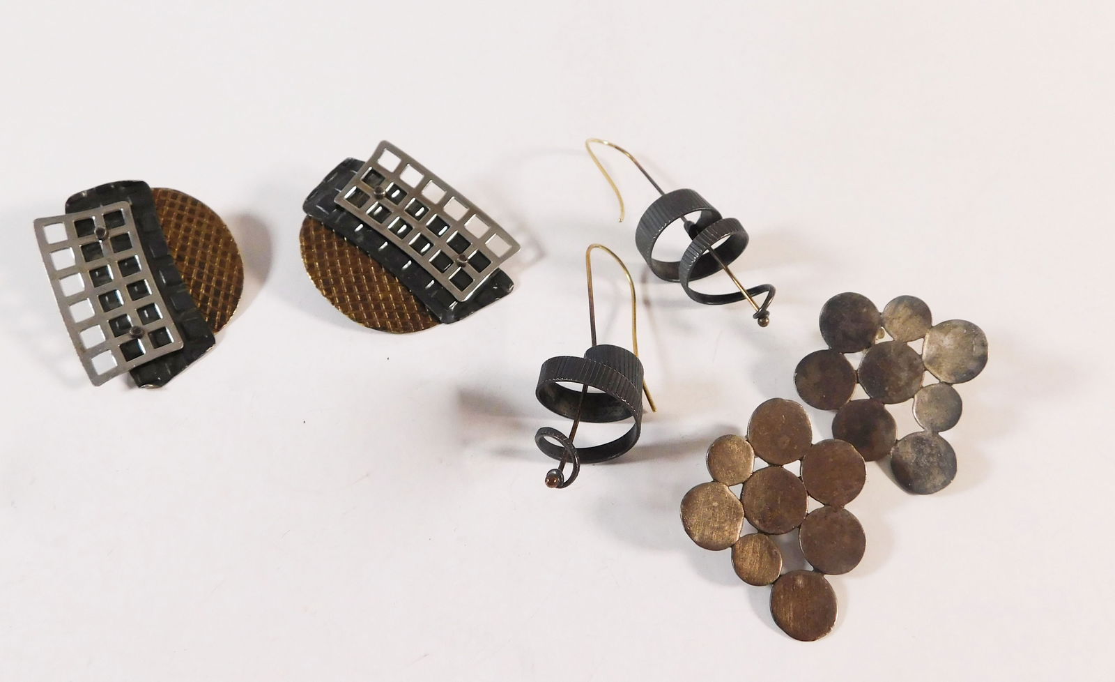 Three Pairs of Mixed Metal Earrings: A collection of mixed metal earrings. The largest piece measures approximately 1.5 inches. Total weight is 39.7g