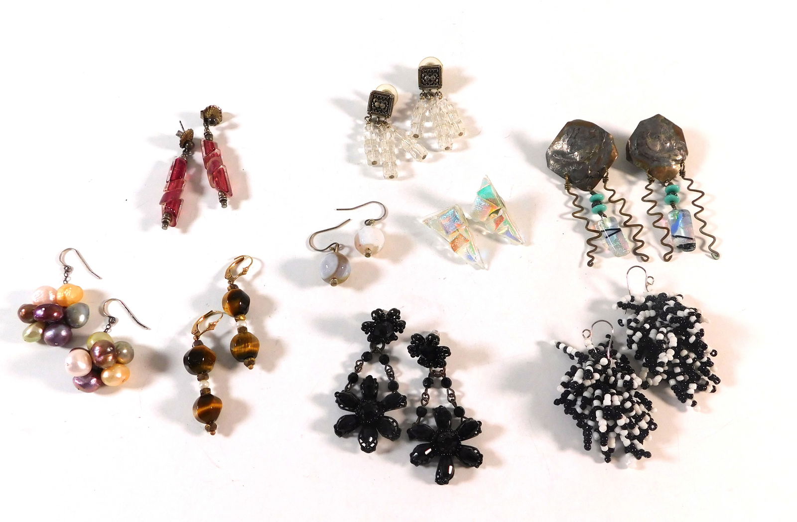 Nine Pairs of Earrings: Collection of nine pairs of fashion earrings. Includes beaded, jeweled, and metal designs. 