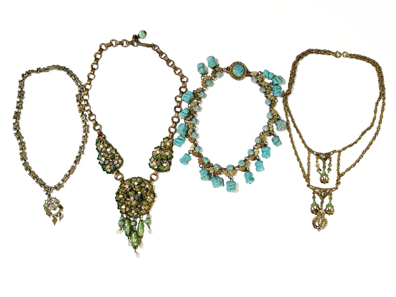 Four Enamel and Stone Costume Jewelry Necklaces: Set of four costume jewelry necklaces with enamel detailing, glass beads, pearls, and turquoise stones. Includes one unsigned Kramer collection enameled necklace. Largest necklace measures
