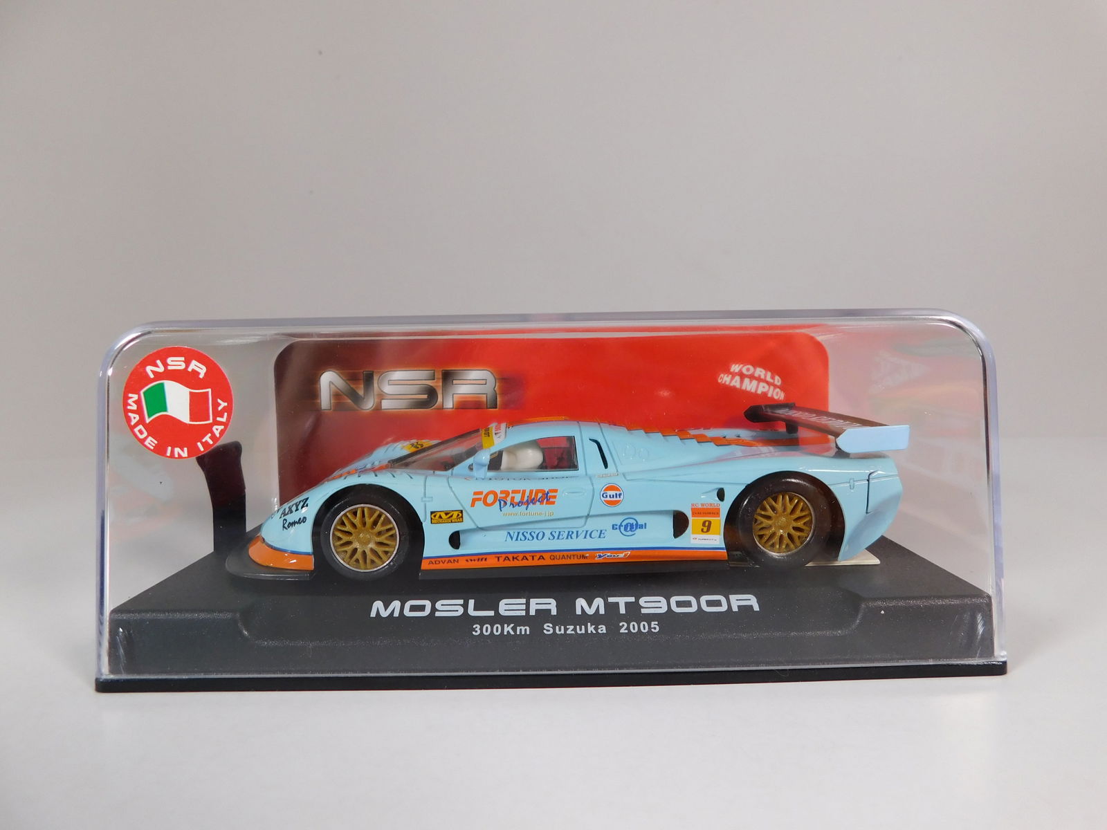 NSR Mosler MT900R 300km Suzuka 2005 #9: NSR 1004 Mosler MT900R 300km Suzuka 2005 #9 Gulf 1/32 Slot Car, with original case. Weight: 7.2 oz.