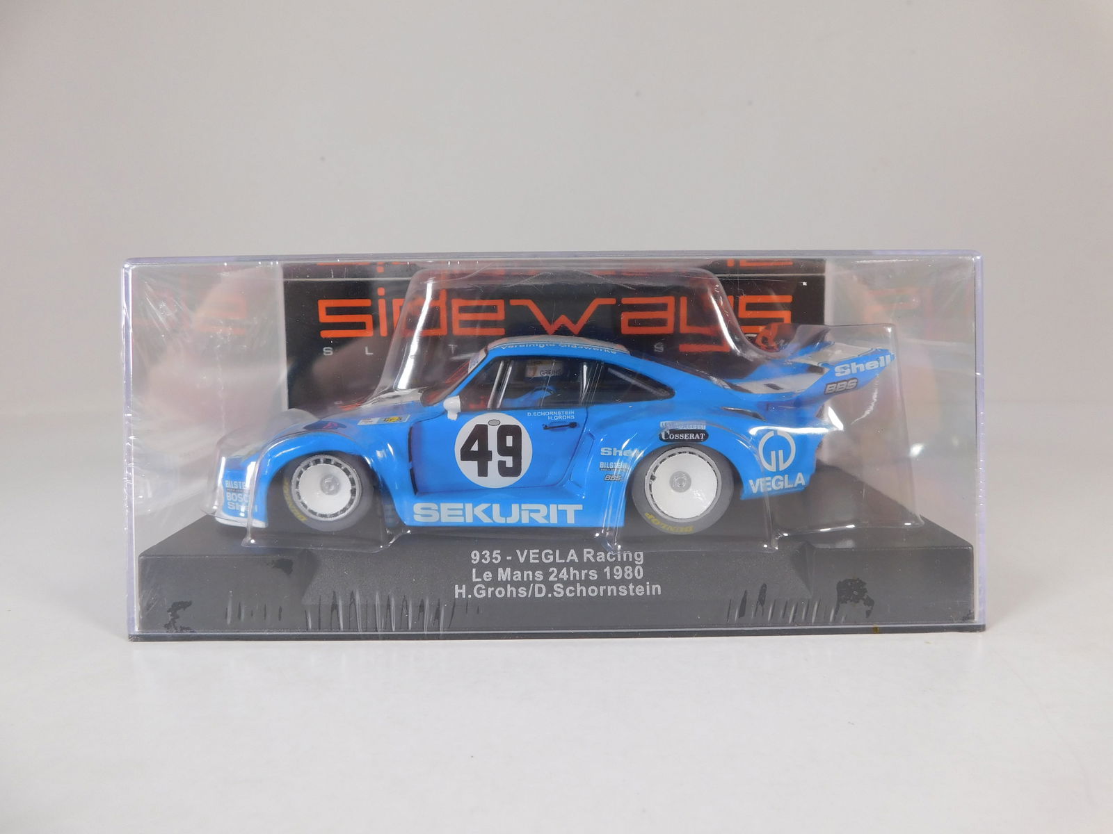 Sideways 935-VEGLA Racing #49 Le Mans 24h. 1980: Sideways 935-VEGLA Racing Le Mans 24h. 1980 H.Grohs / D.Schornstein #49 Sekurit 1/32 Slot Car. Reference #SW38. Chassis / Motor Reference #SW32, with original case. Weight: 7 oz. Shrink-wrapped. 