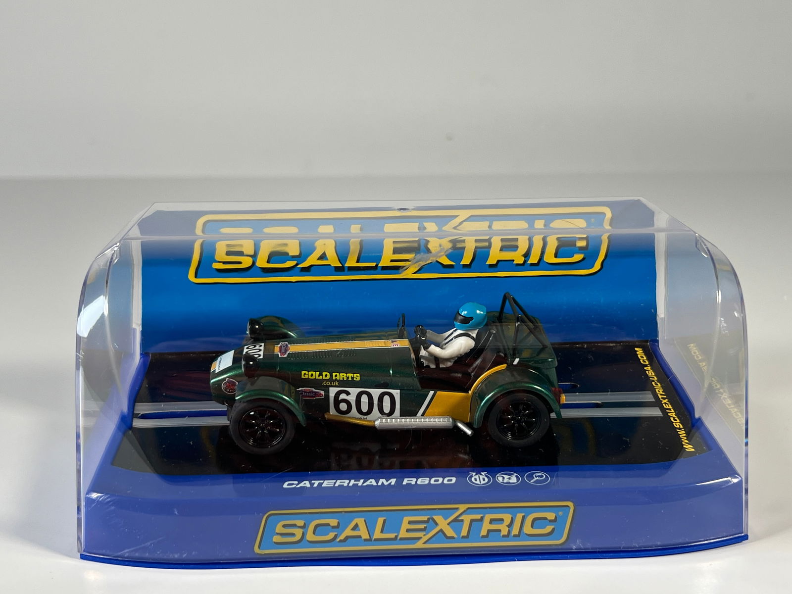 Scalextric Caterham R600 2013 Magnificent Sevens Series #600: Scalextric Caterham R600 Jon Barnes 2013 Magnificent Sevens Series #600 Gold Arts 1/32 Slot Car. Reference #C3309, with original case. Weight: 7.2 oz.