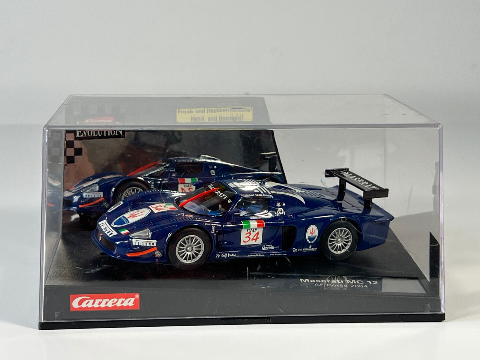 Carrera Evolution Maserati MC12 AF Corse 2004 #34: Carrera Evolution Maserati MC12 AF Corse 2004 #34 Pirelli 1/32 Slot Car, with original case. Weight: 14.8 oz.