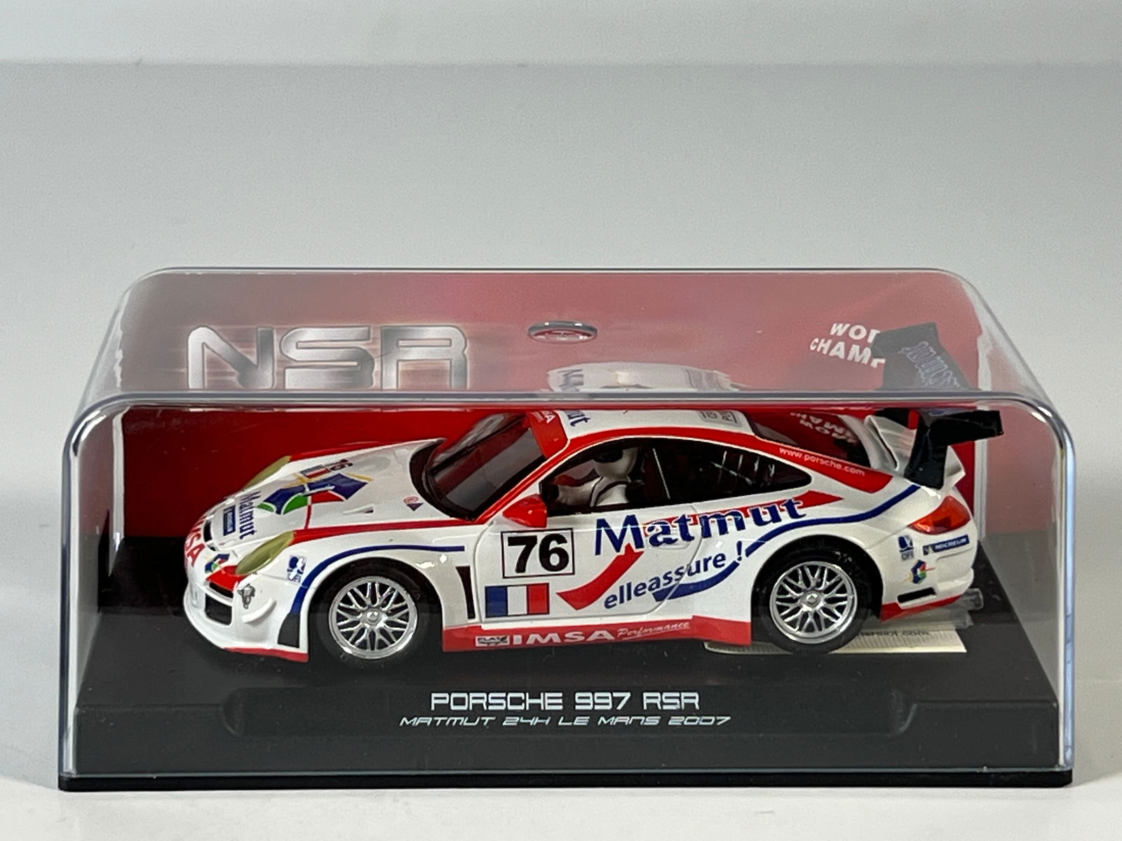 NSR Porsche 997 RSR 24H Le Mans 2007 #76: NSR 0035 Porsche 997 RSR Matmut 24H Le Mans 2007 slot car. White with red and blue accents, #76. Display case included. Weight: 7.7 oz.