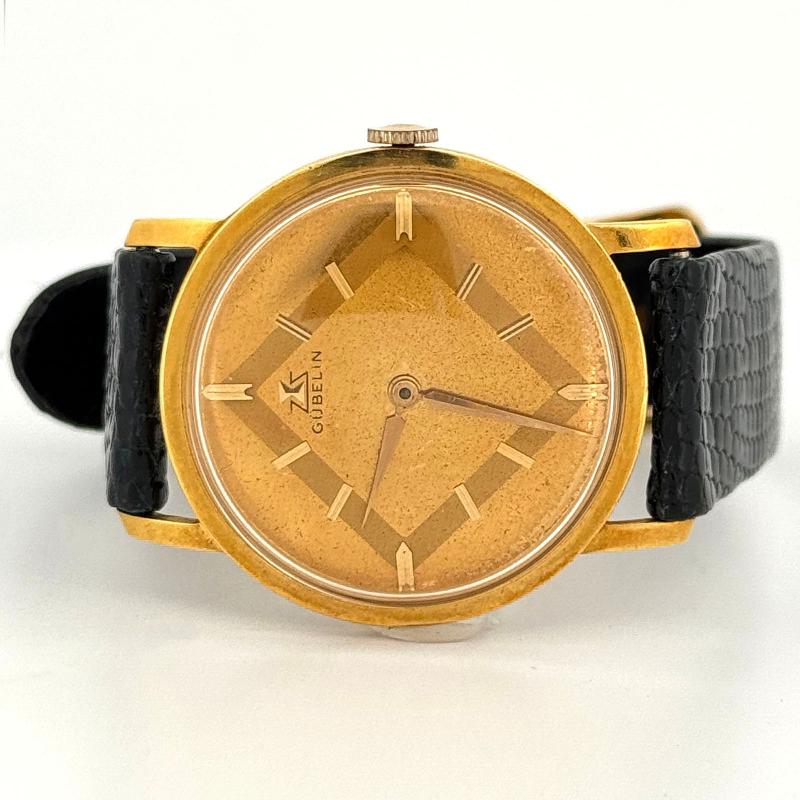 Gubelin 18K Gold Wristwatch: This Gubelin men's watch stands out with its timeless elegance. Crafted entirely from 18K rose gold, the attractive gold toned dial has a lovely patina and features a diamond patterned inner dial