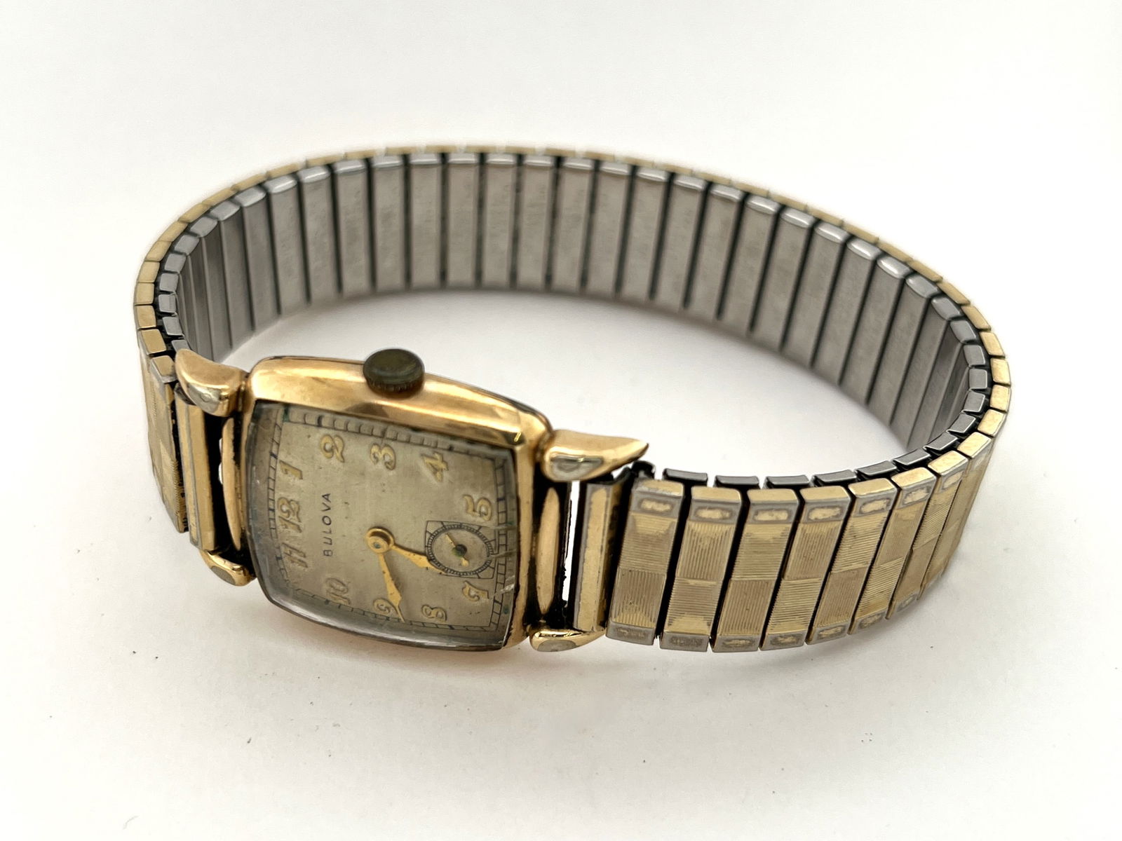 Vintage Bulova 10BH Wristwatch 10k Gold Filled: Vintage Bulova wristwatch with a 10k gold-filled case and expansion band. The movement is marked 'Bulova Watch Co. USA' and '10 BH 21 Jewels'. The caseback is inscribed