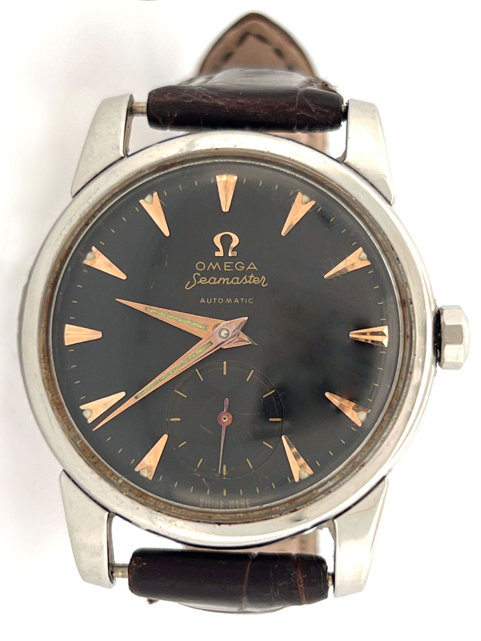 Vintage Omega Seamaster Automatic Watch: Vintage Omega Seamaster automatic wristwatch. Features a stainless steel case, dark dial with gold-tone markers, and a sub-seconds dial. Fitted with a brown leather strap.