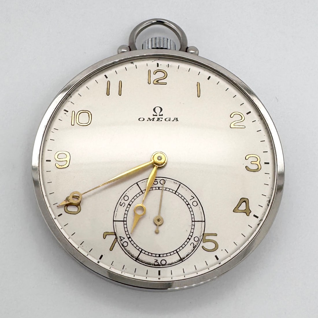 1930's Omega Openface Stainless Steel Pocket Watch, 15 Jewels, Serial #8764380: Vintage Omega stainless steel pocket watch featuring a silver-tone case, white dial with gold-tone numerals and hands, black minute track and logo, and a seconds sub dial. The movement is marked