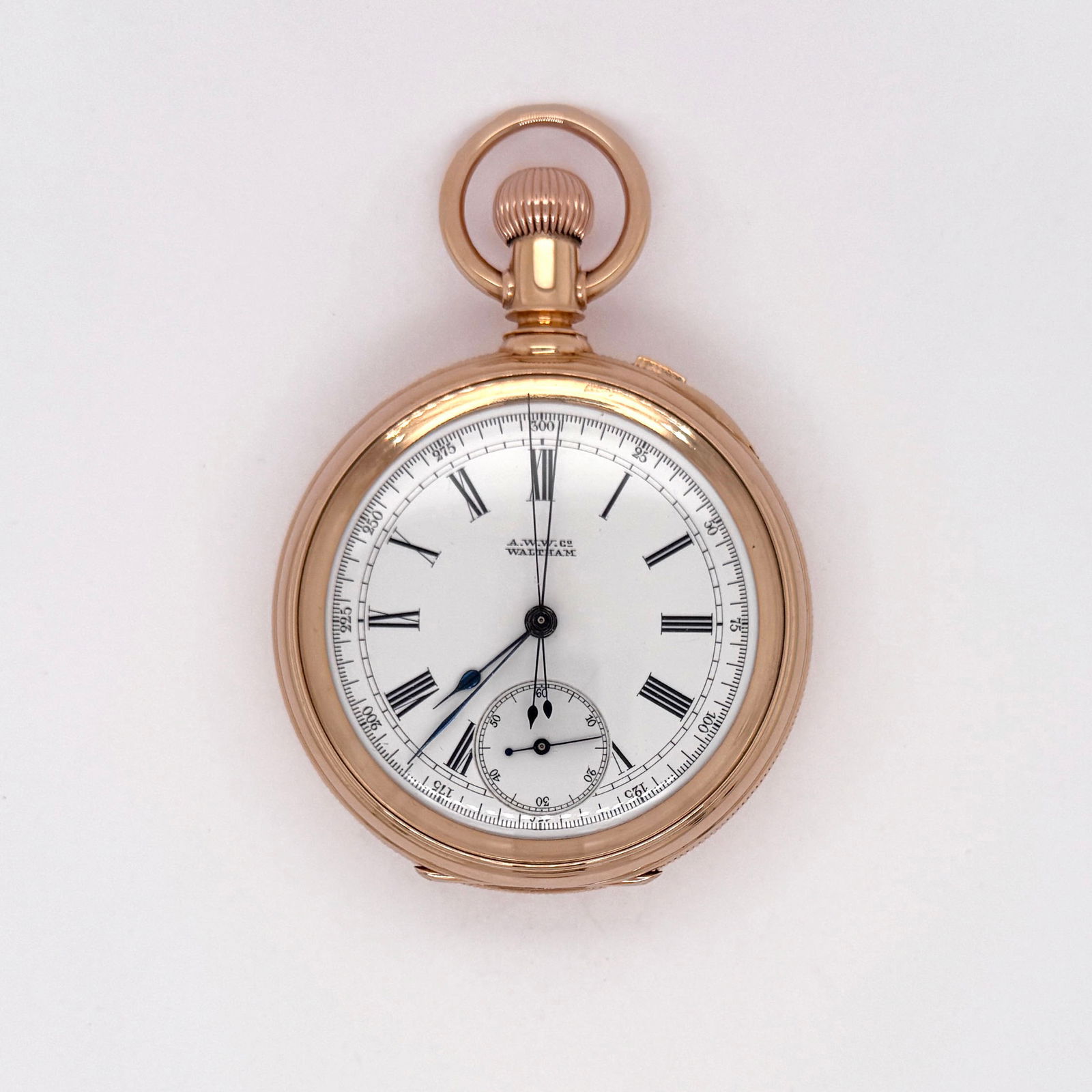 A.W.W. Co. Waltham 18K Gold Split Second Chronograph Keyless Lever Watch: Circa 1885, A.W.W. Co. Waltham pocket watch. Features an 18K gold case, white dial with Roman numerals, and a subsidiary seconds dial. Marked '18K' and 'D396' inside the case.