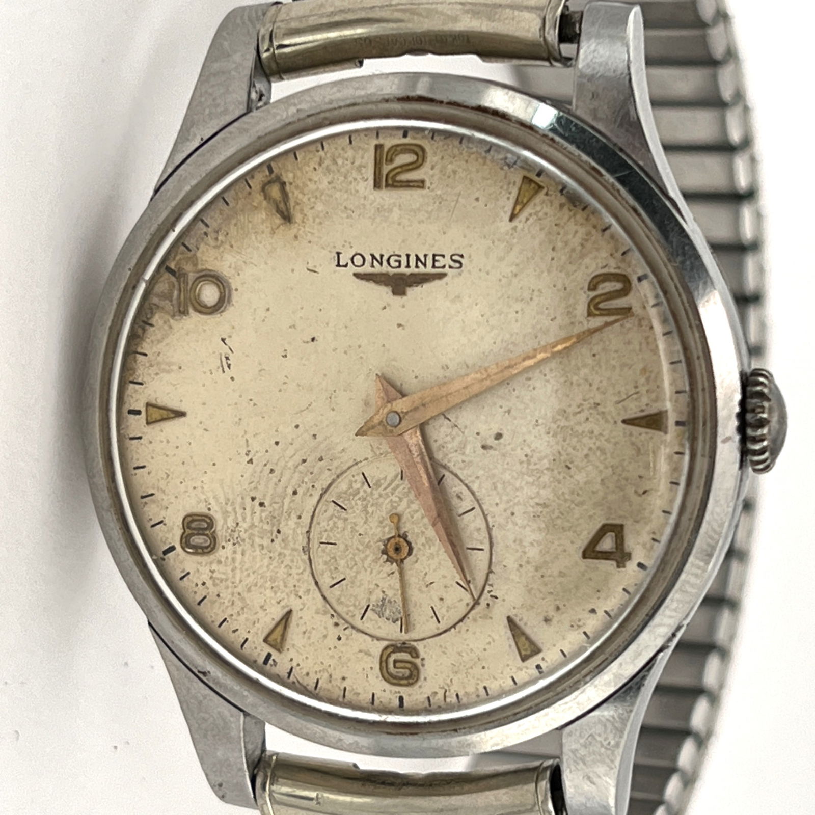 Longines Stainless Steel Wristwatch Serial# 6627106: Longines wristwatch, featuring a stainless steel case, an aged dial with Arabic numerals, and a seconds sub dial at 8 o'clock. The hands and indices are gold toned. The 12.68z 17 jewels movement h
