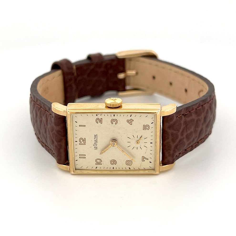 LeCoultre 10K Gold Filled Rectangular Wristwatch: LeCoultre rectangular wristwatch with a 10K gold filled case and brown leather strap. The movement is marked LeCoultre Co. Seventeen 17 Jewels. Case is marked 477049.