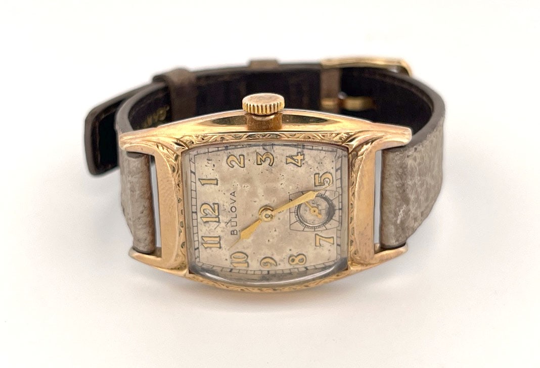 Vintage Bulova 10K Rolled Gold Plate Wristwatch: Vintage Bulova wristwatch featuring a 10K rolled gold plate case with decorative engraving. The watch has a subsidiary seconds dial and a 17-jewel movement. The case back is stainless steel. Includes