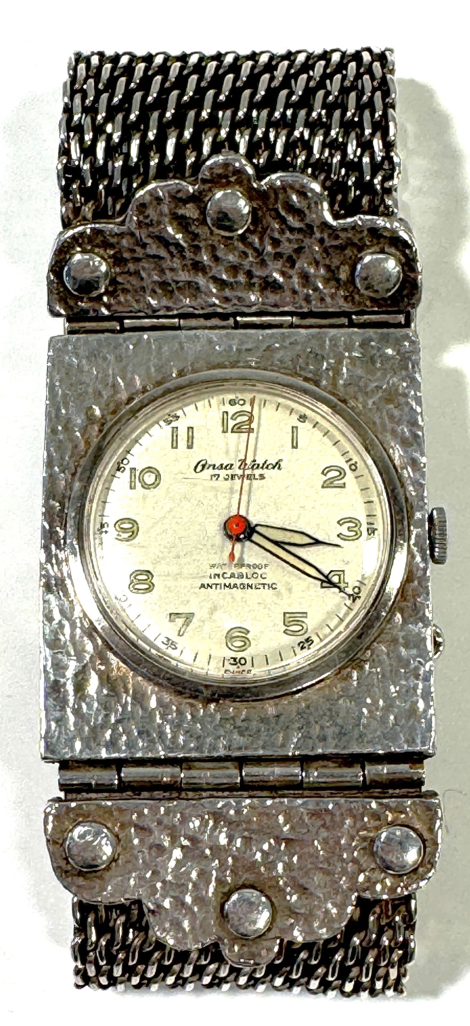Orsa Watch 17 Jewels with Hammered Silver Tone Bracelet: Orsa Watch, 17 Jewels, Incabloc, Antimagnetic. Features a hammered silver tone case and matching mesh bracelet. The watch has a white face with black numerals and hands, and a red second hand. Not