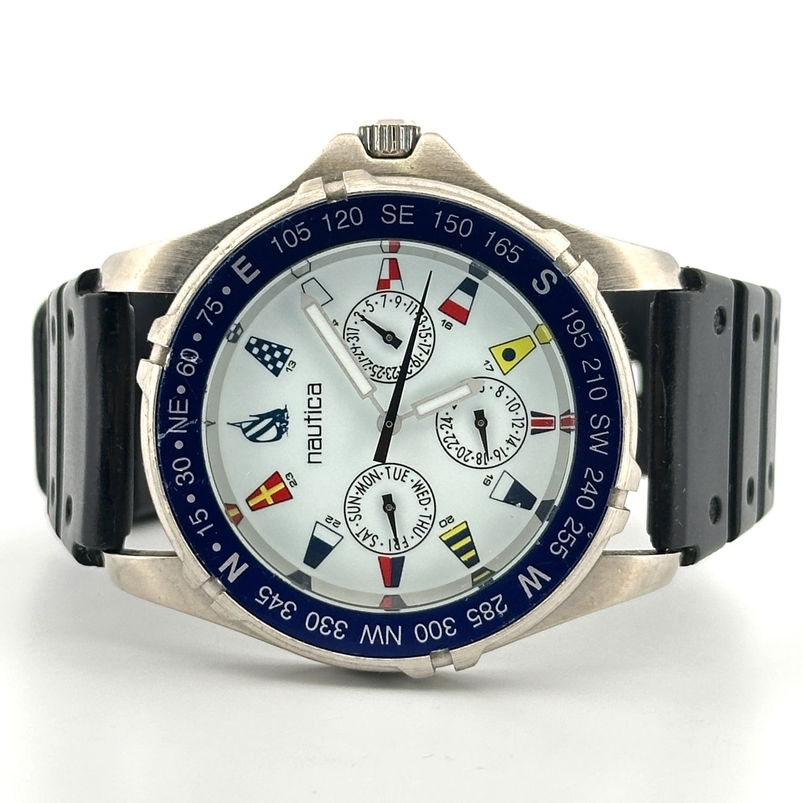 Nautica D9 Quartz Wristwatch with Signal Flag Dial: Nautica D9 wristwatch featuring a white dial with signal flag hour markers and day, date, and 24 hr subdials. Stainless steel case with a black rubber strap. Water resistant to 50m. Powered by