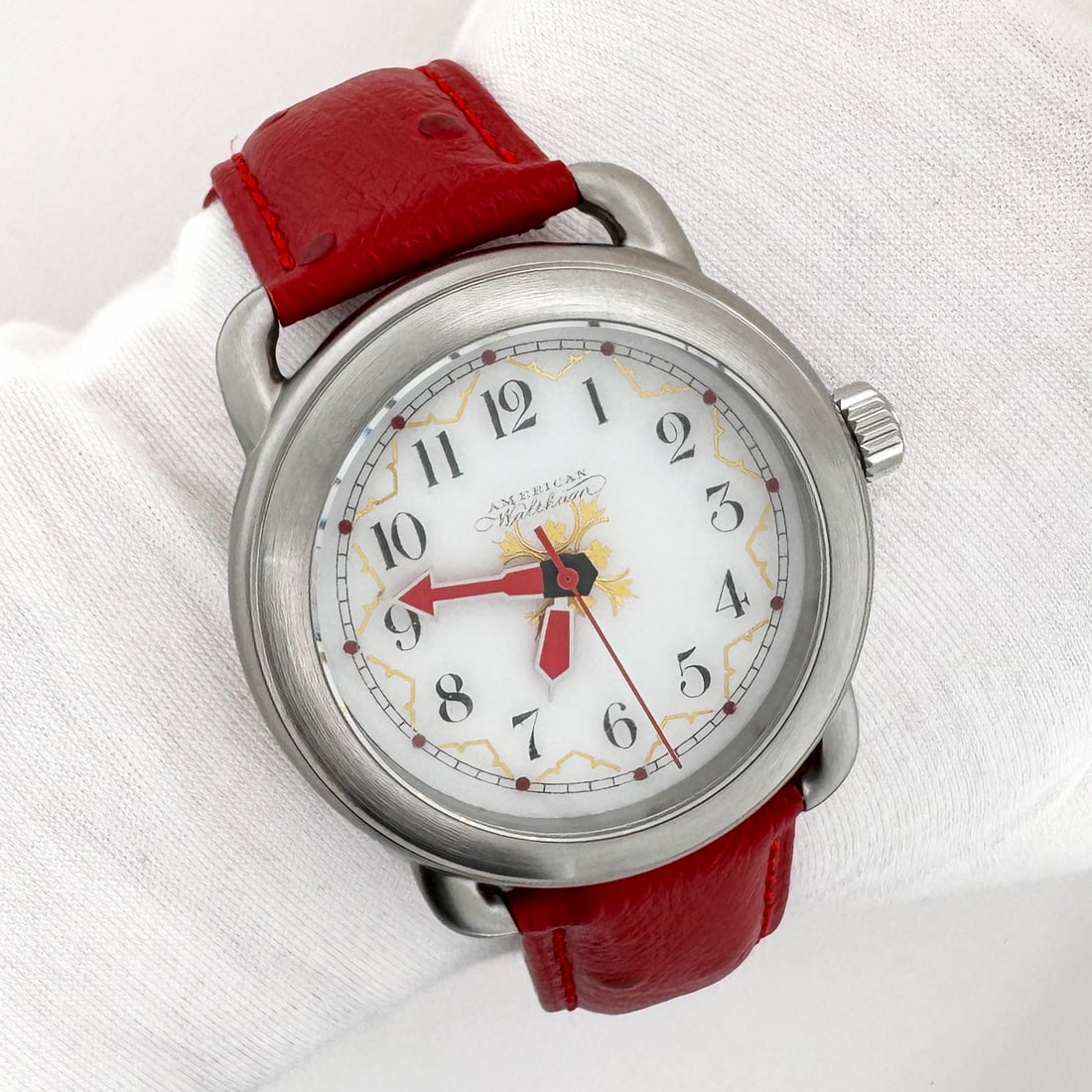 Waltham Gold & Red Dial Conversion Automatic Wristwatch: Custom wristwatch featuring a gold and red accented Waltham dial from turn of 19th century. The watch has a stainless steel case rated for 200M water resistance, and it is paired on a red leather