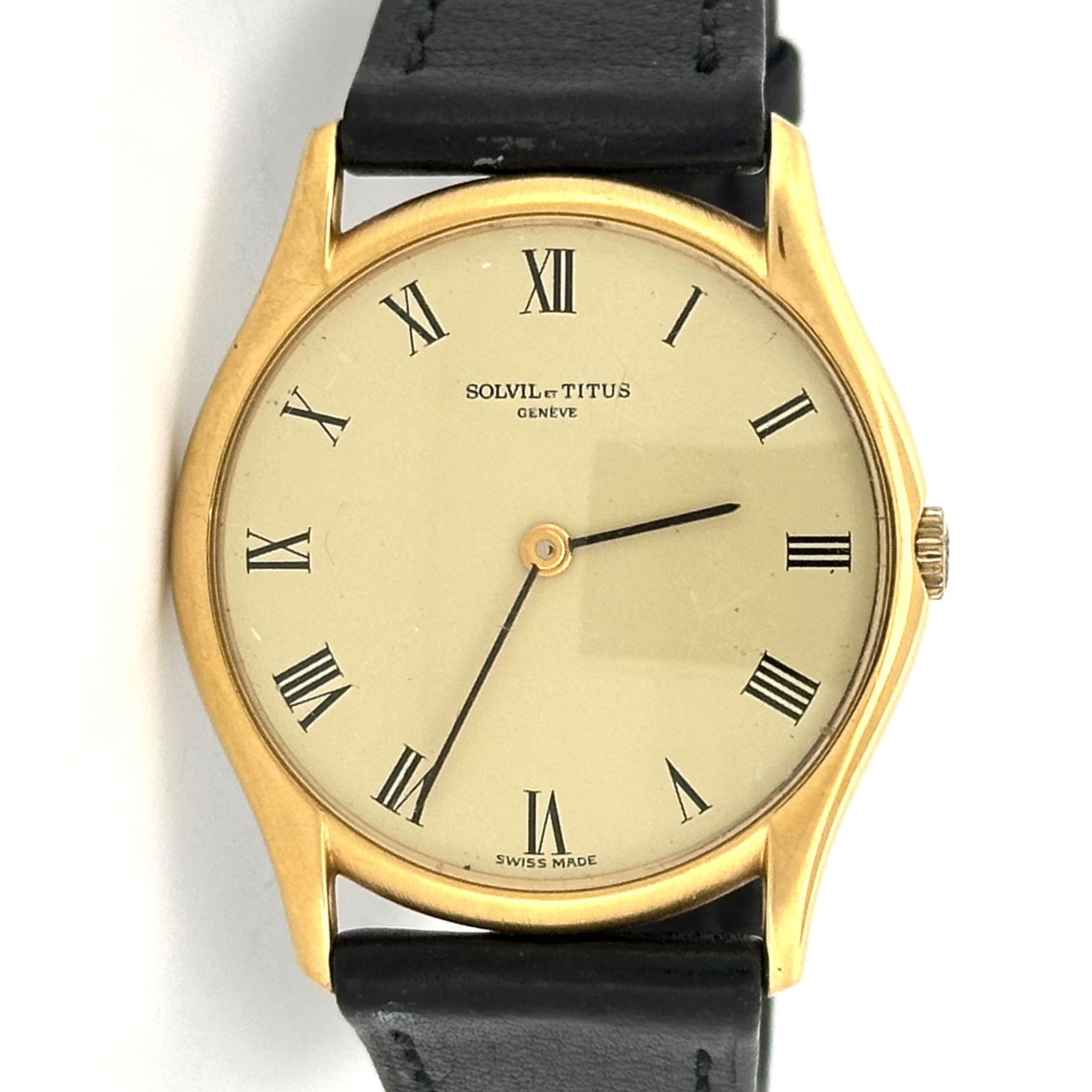 Solvil et Titus Geneve Gold Tone Wristwatch: Solvil et Titus Geneve wristwatch powered by the Peseux 330 manual wind movement. Gold tone case with black leather band. Roman numeral markers. Marked 9498 on the back.