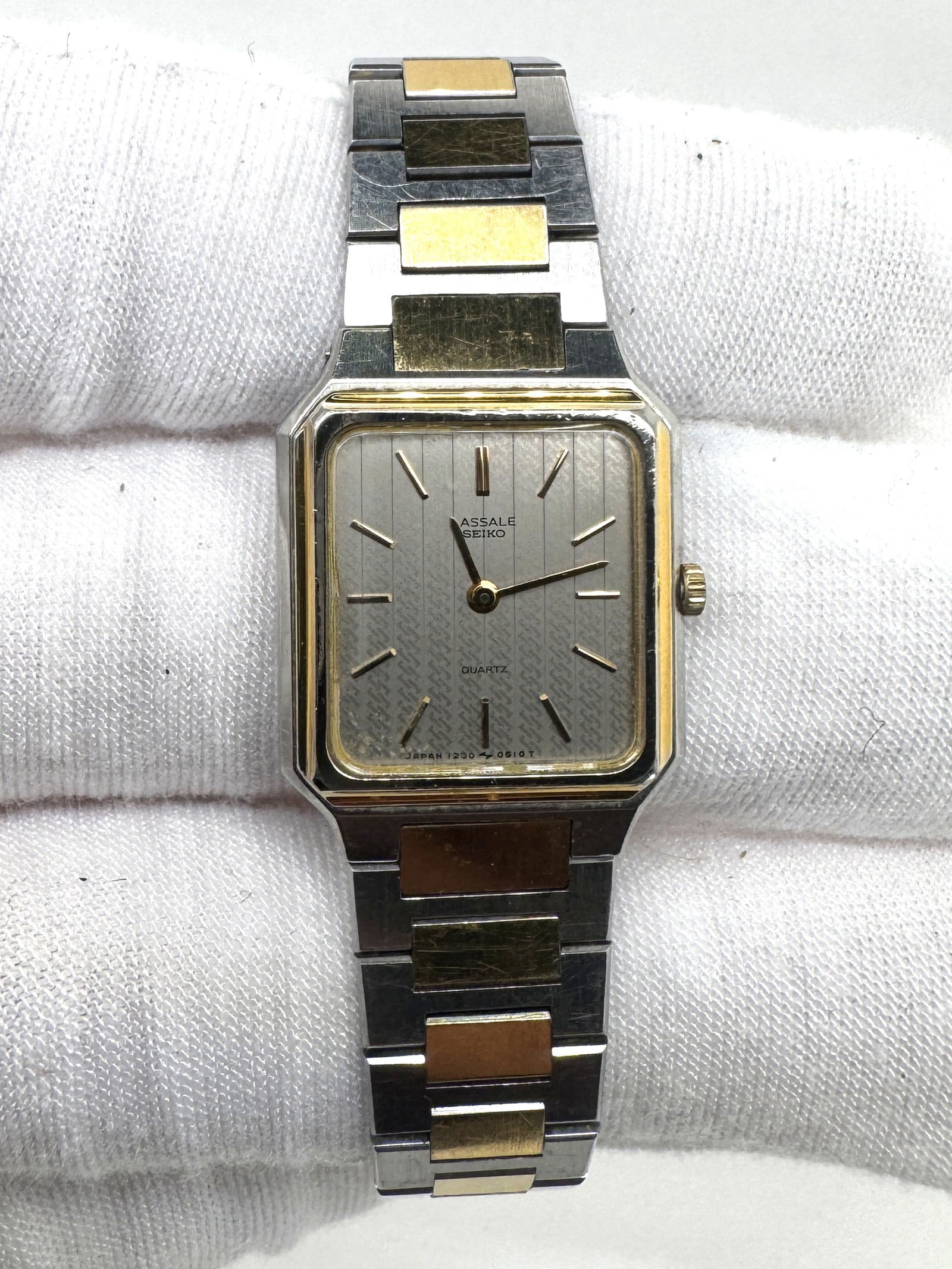 Lasalle Seiko Two-Tone Quartz Wristwatch: Lasalle Seiko quartz wristwatch with a two-tone bracelet. Features a square silver-tone dial with gold-tone accents and hands.