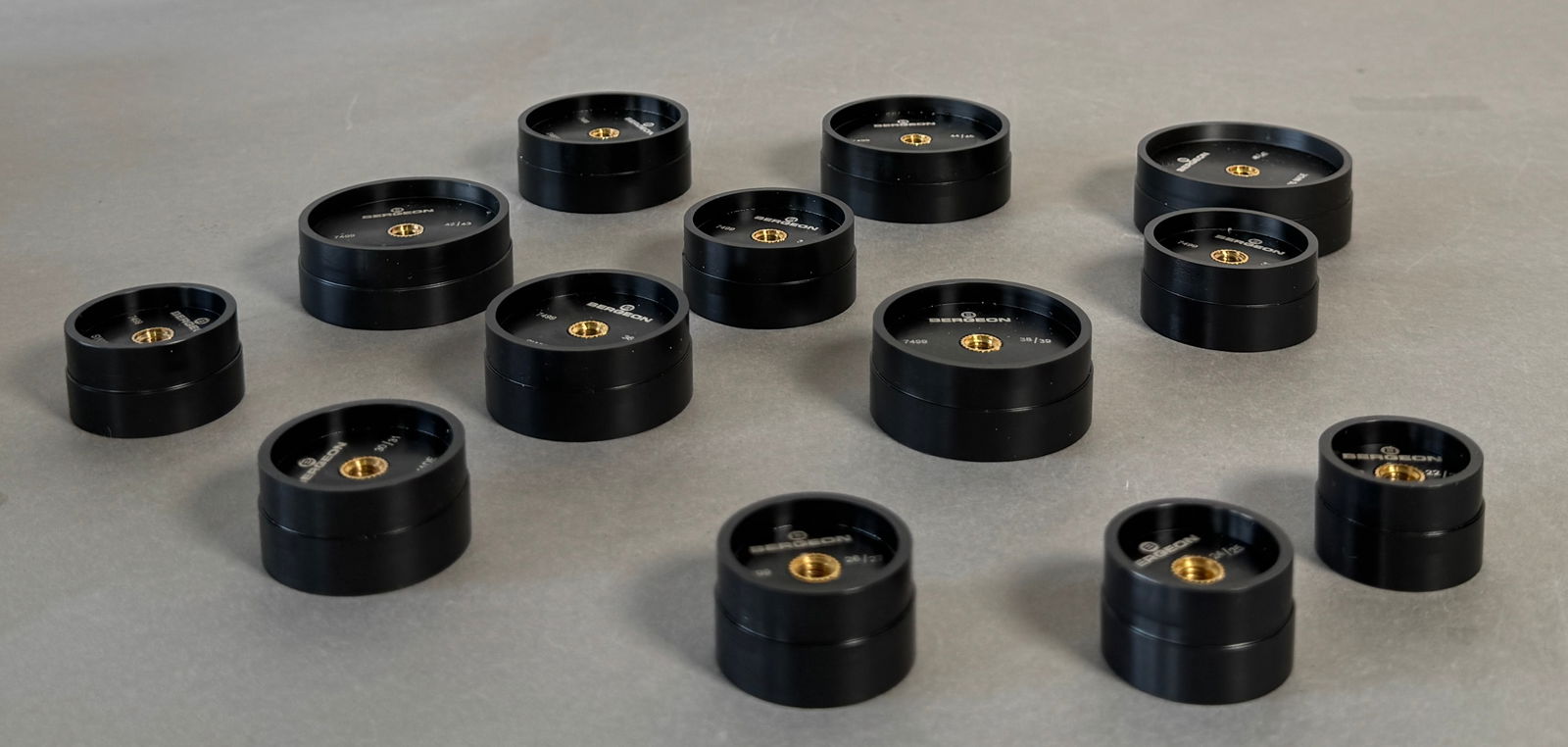 Bergeon 7499-A 13 Reversible Synthetic Watch Press Dies: Bergeon 7499-A is 13 piece set of black synthetic dies have straight sides and are reversible. They have a 6mm threaded hole and fit the Bergeon 5500 case press. Total weight with the