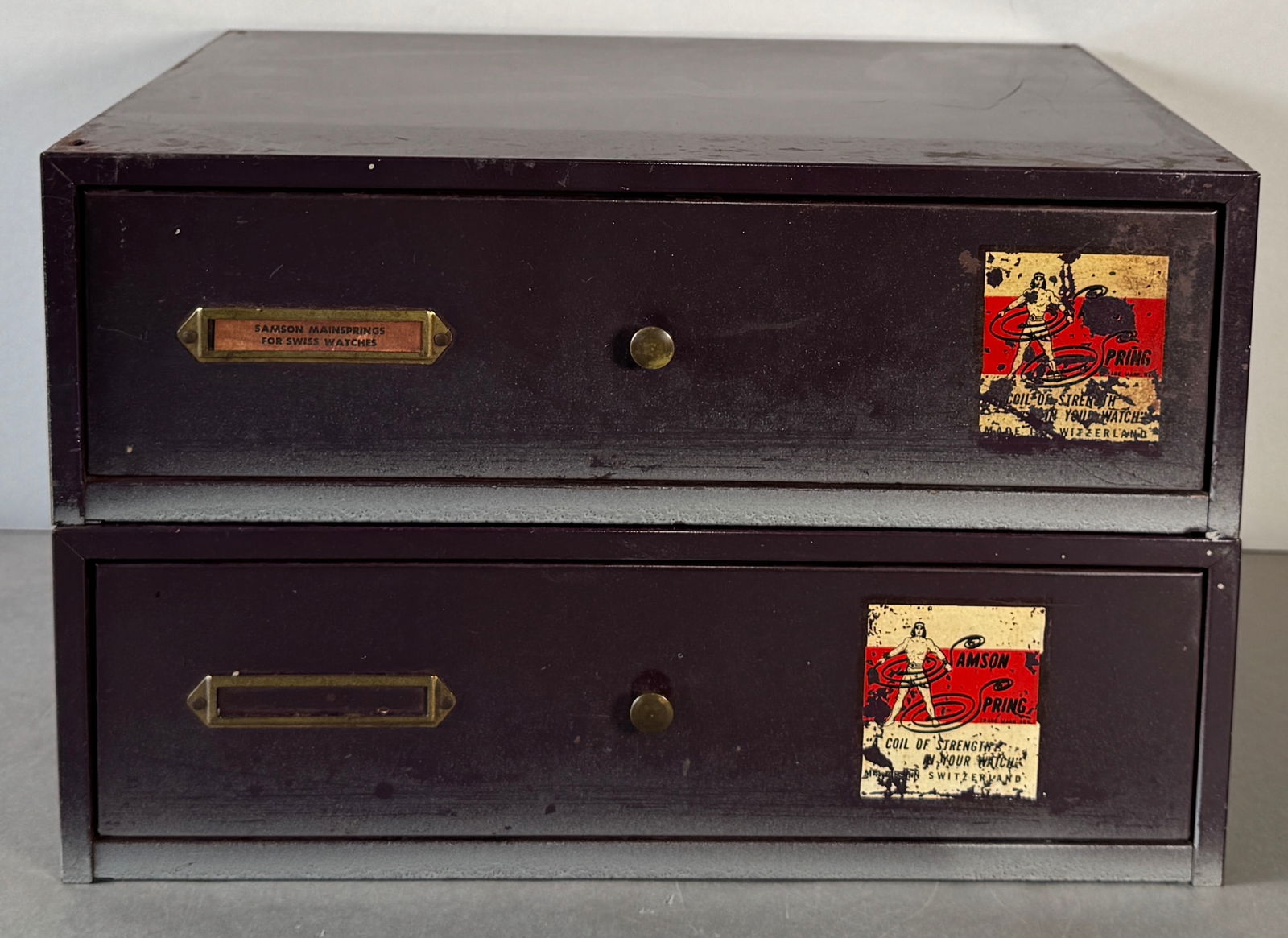 Vintage Samson Spring Two-Drawer Cabinet of Swiss Mainsprings: Two-drawer Samson Springs vintage cabinet filled with an assortment of Swiss mainspring parts. Dimensions: 8.5 x 13.25 inches. Weight: 22.68 lbs.