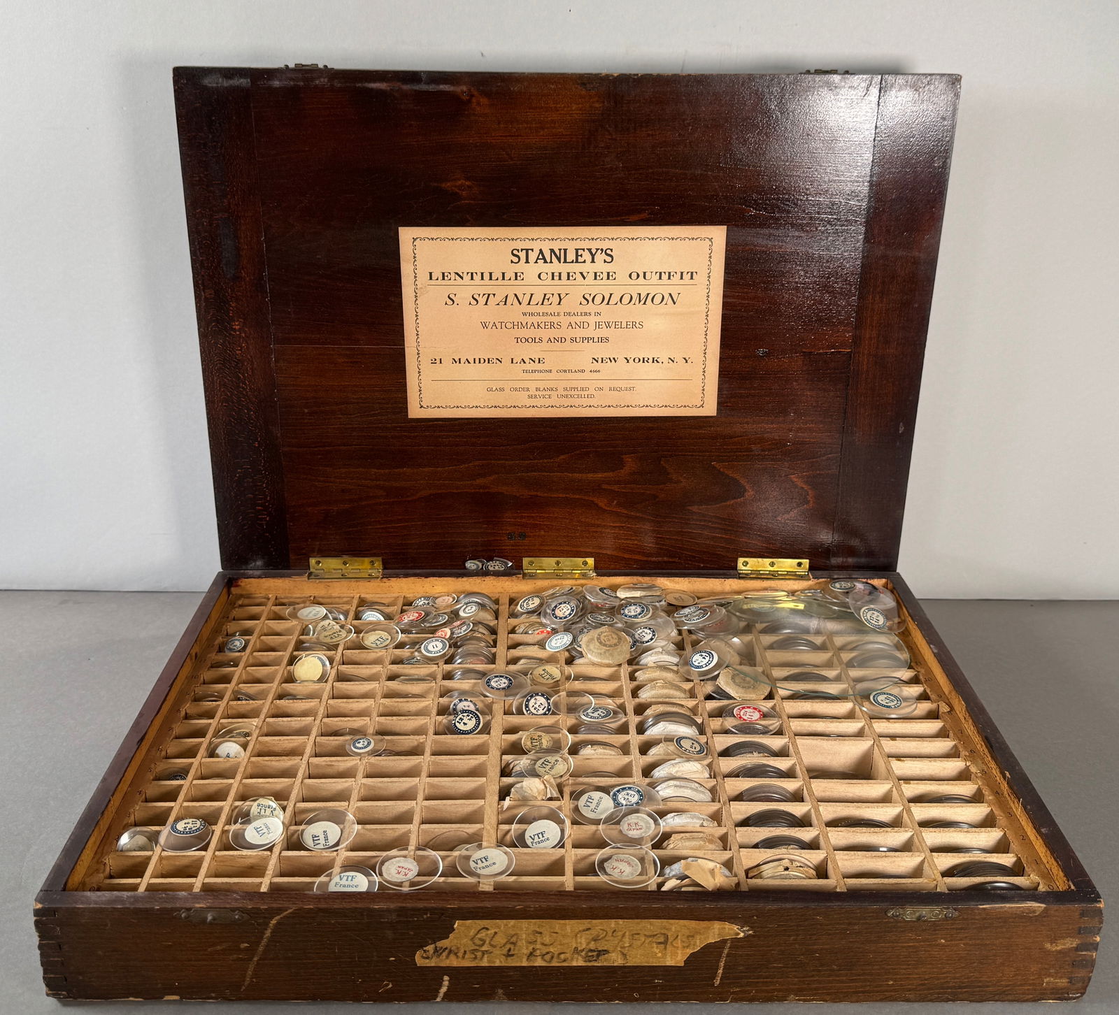 Stanley's Lentille Chevee Outfit Lens Set: Stanley's Lentille Chevee Outfit by S. Stanley Solomon. A wooden box containing a large assortment of pocket watch crystals. Box measures approximately 2.75 x 18.75 inches. Weight: 130.3oz. 