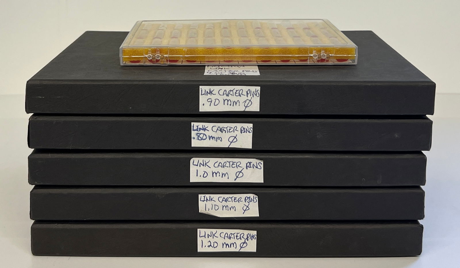 Jules Borel Watch Link Carter & Cotter Pin Assortment: Collection of Jules Borel watch link carter and cotter pin assortments. Includes various sizes of link carter pins and cotter pins, neatly organized in labeled boxes and vials. A comprehensive set