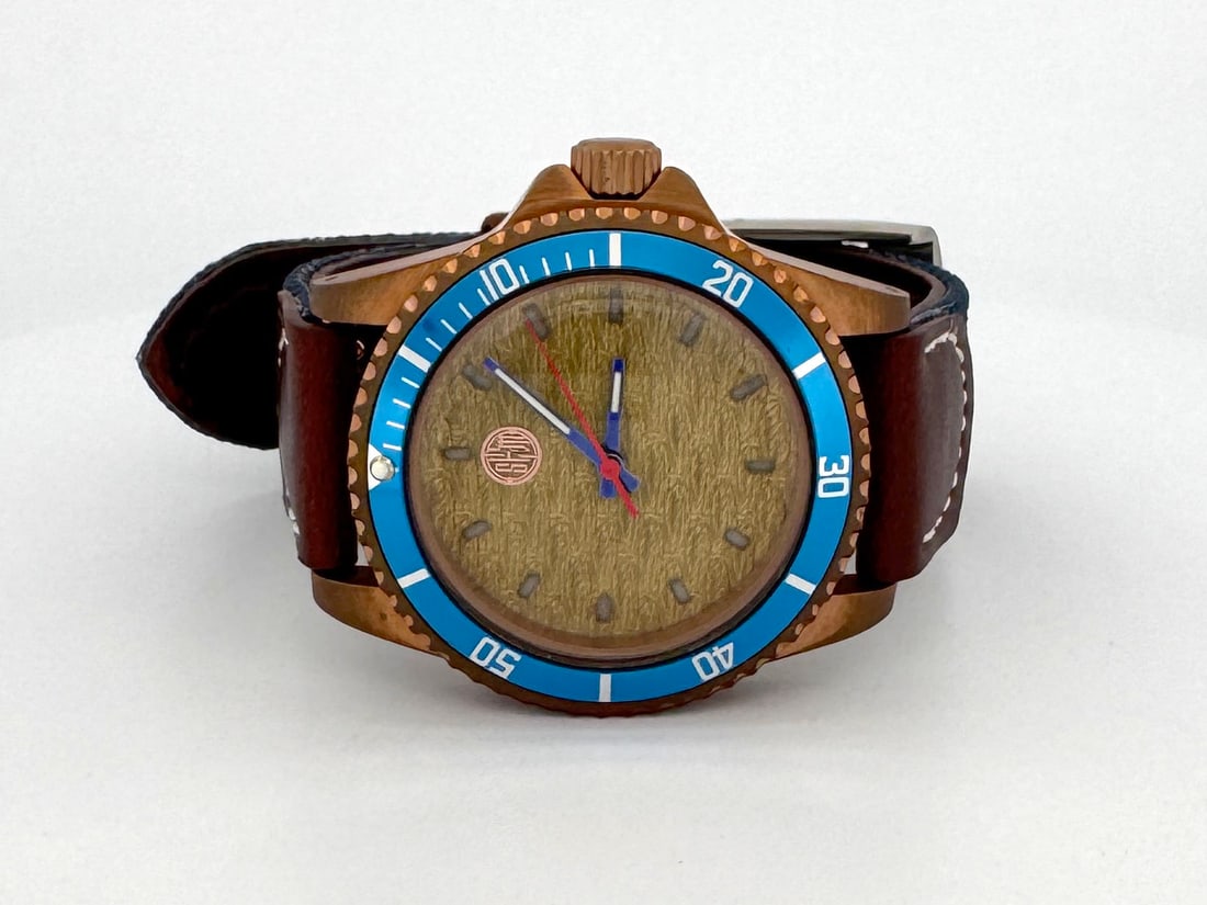 Ocean Weaver by SHM Creations: The Ocean Weaver is a bronze diver showcasing a custom textured dial with high lume indices. It is powered by a Seiko automatic movement and is presented on a leather and canvas combination strap for