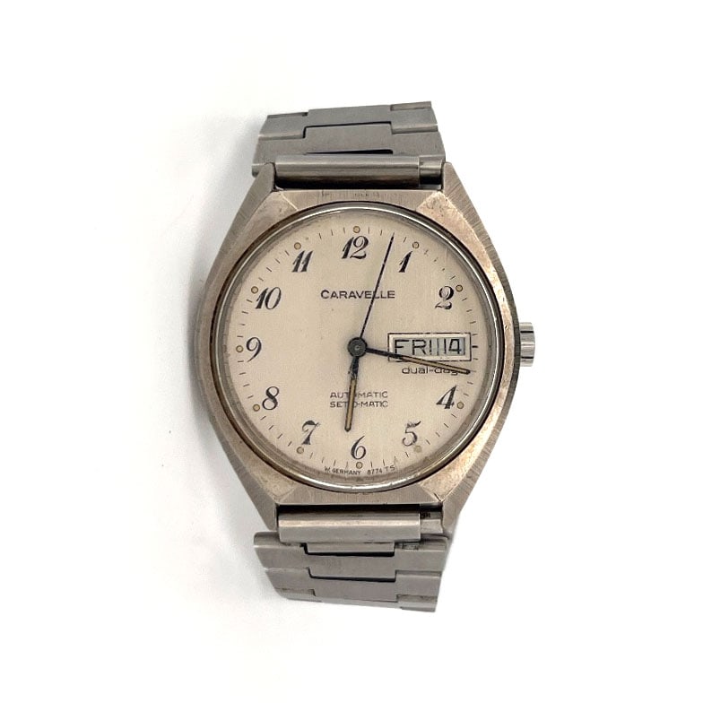 Caravelle Automatic Set-O-Matic Day-Date Wristwatch: Caravelle Set-O-Matic automatic wristwatch with day-date function. Stainless steel case and bracelet. Seventeen jewel movement.