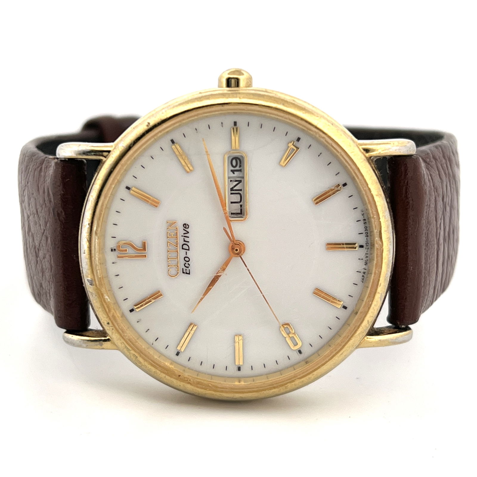 Citizen Eco-Drive Gold Tone Wristwatch: Citizen Eco-Drive wristwatch with a gold-tone case, white dial, and brown leather strap. Features day/date display.