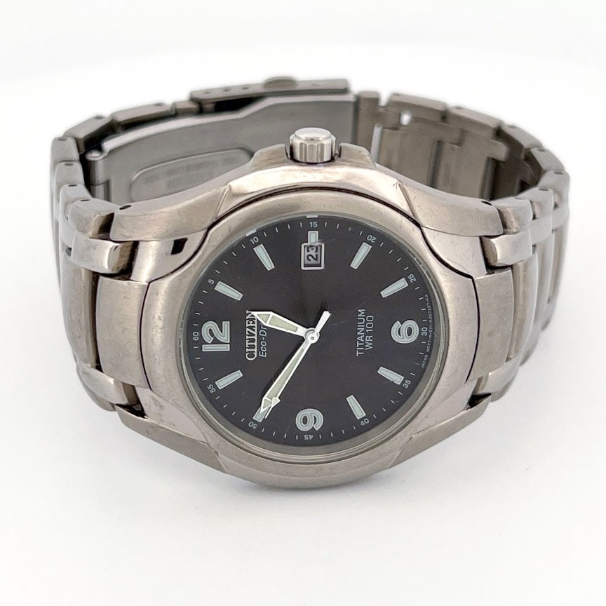 Citizen Eco-Drive Titanium WR100 Wristwatch: Citizen Eco-Drive wristwatch BM6060-57F with a silver titanium band and case. The 40mm a black dial with luminous hands and markers, and a date window. It is driven by the Eco-Drive light-powered