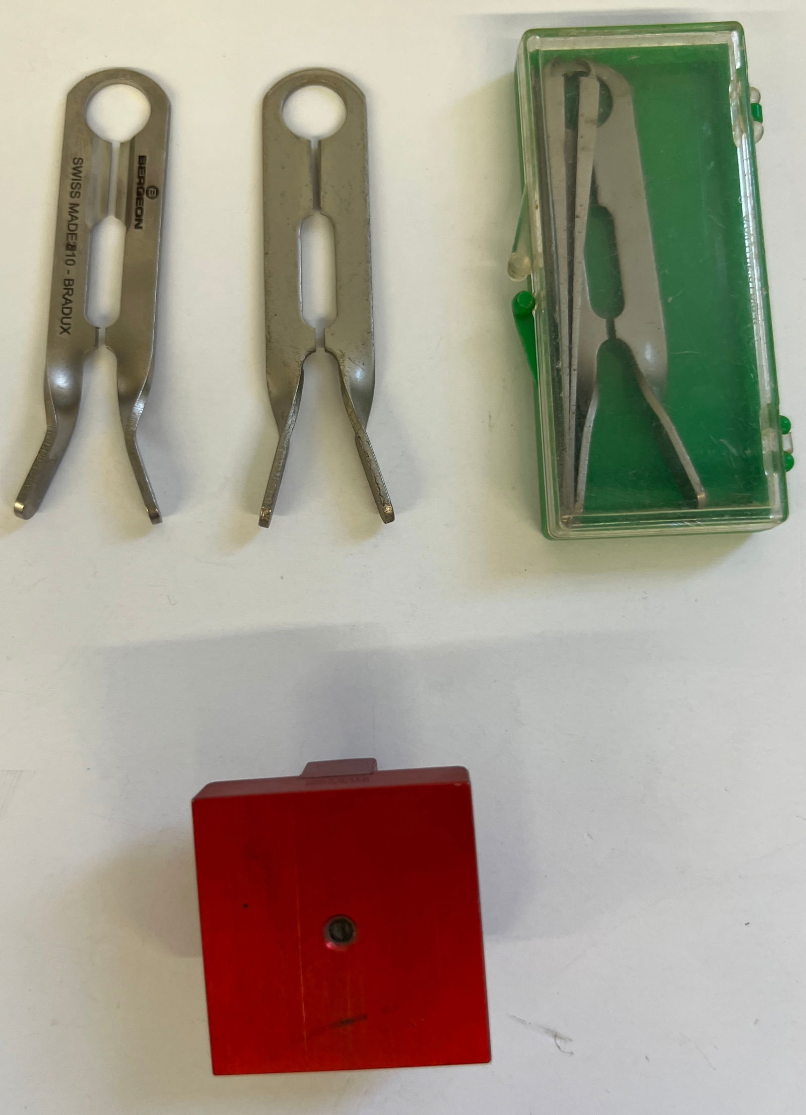 Various Friction Fit Roller Remover Tools: Set of friction fit roller remover tools. Includes three hand removal tools (including a Bergeon), a red base, and a green storage case. Marked 'Swiss Made'.
