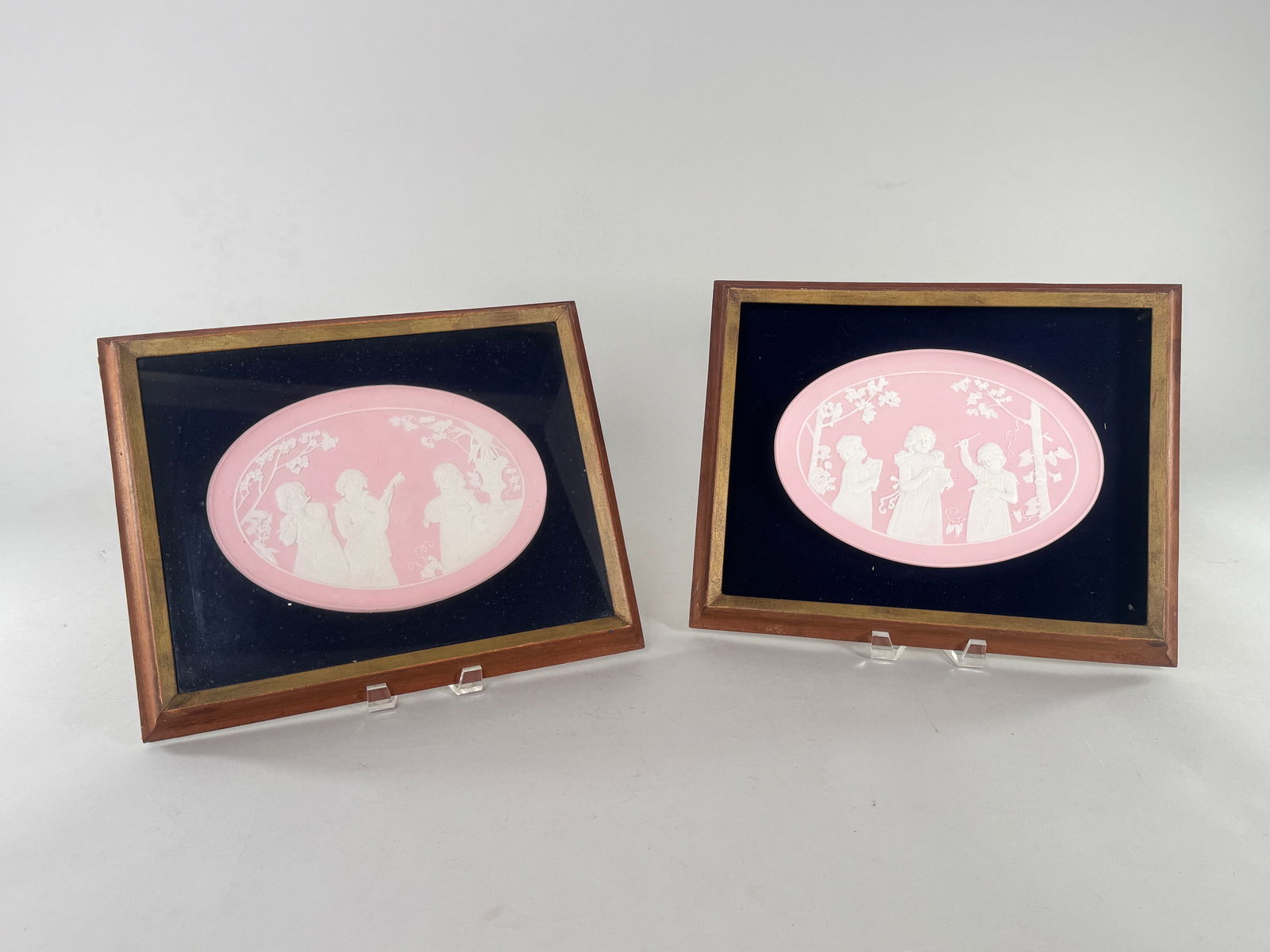 Pair of Framed Pink Jasperware Plaques: Pair of framed pink jasperware plaques. Frame dimensions: 15.5 x 12.5 inches. Art dimensions: 10.5 x 7.5 inches. Both are framed and matted.