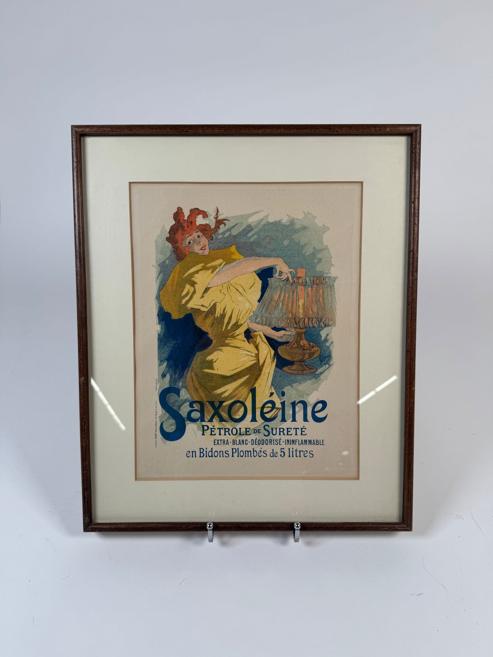 Framed Saxoleine Advertising Print: Framed Saxoleine advertising print. Frame measures 18 x 15 inches, while the print itself measures 13 x 10 inches. Embossed stamp lower-right.