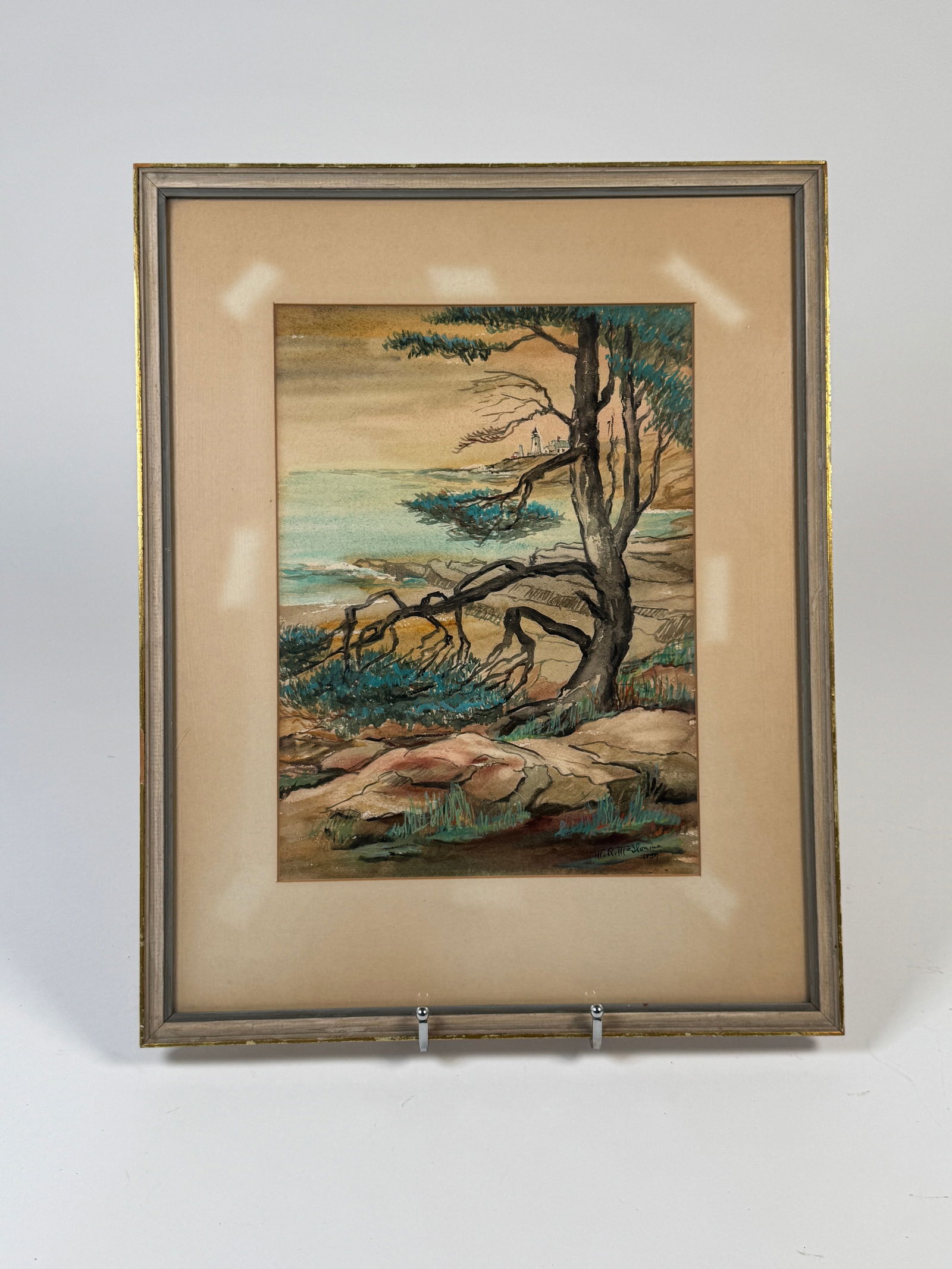 Coastal Landscape Watercolor - Mary Ruth McIIvaine, 1957: Watercolor painting depicting a coastal landscape by Mary Ruth McIIvaine. Signed bottom right. The work is framed and matted. Dimensions: 19.5 x 15.5 inches.
