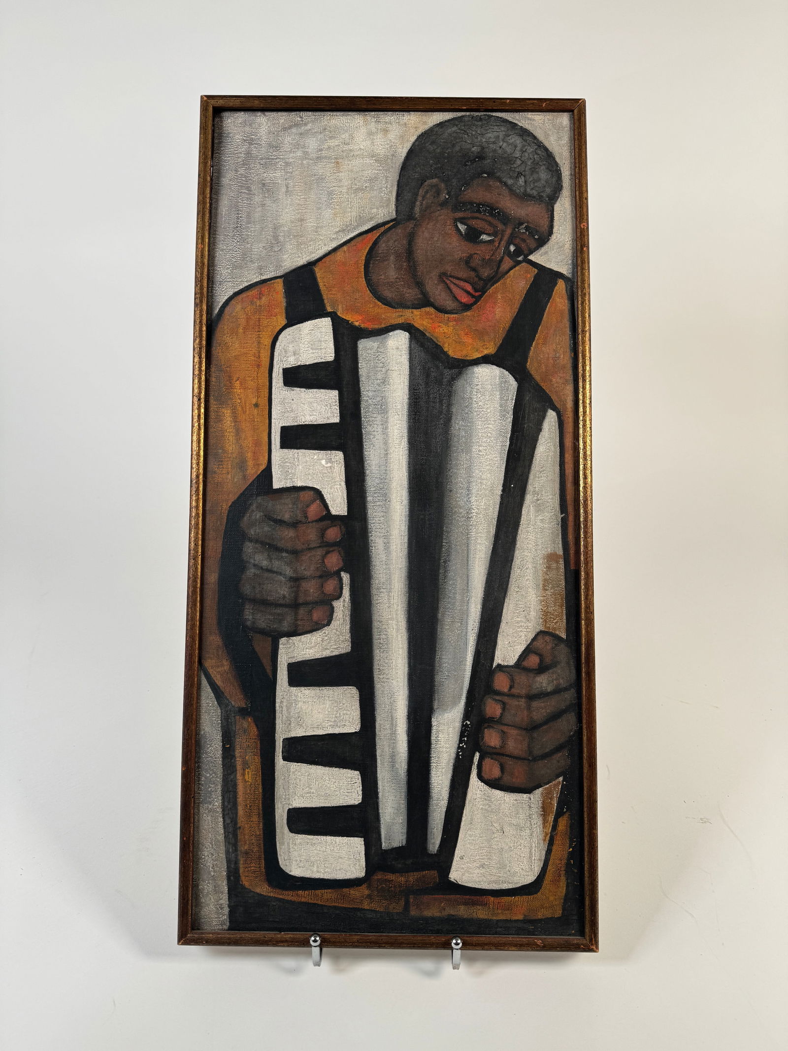 Figurative Painting of a Man Playing Piano, Framed: Framed painting depicting a man playing a piano. The painting measures 23 3/4 x 10 7/8 inches, and the frame measures 25 x 12 inches. The artwork features bold lines and a distinctive color palette.