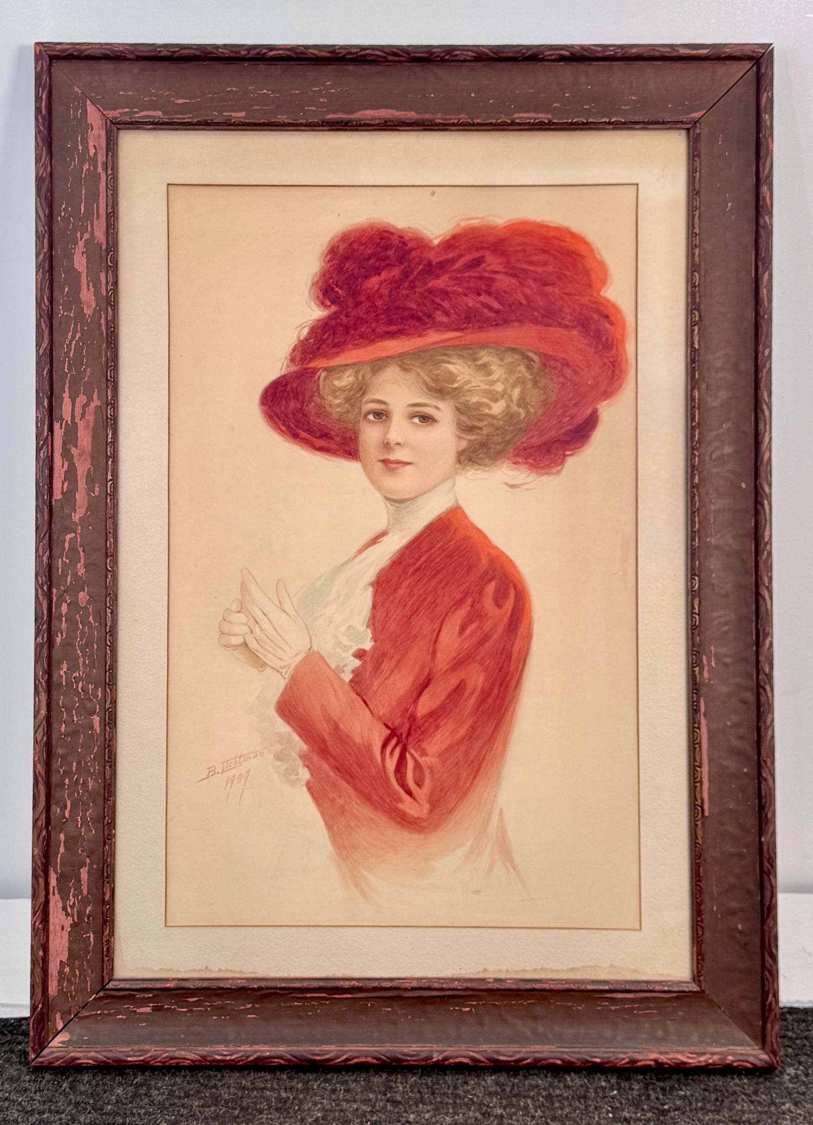 Ben Lichtman, Portrait of a Woman in Red, 1909: Portrait of a woman in a red hat and jacket, signed B. Lichtman and dated 1909. Framed. Frame: 37 x 27 inches; Print: 27.5 x 17.5 inches.