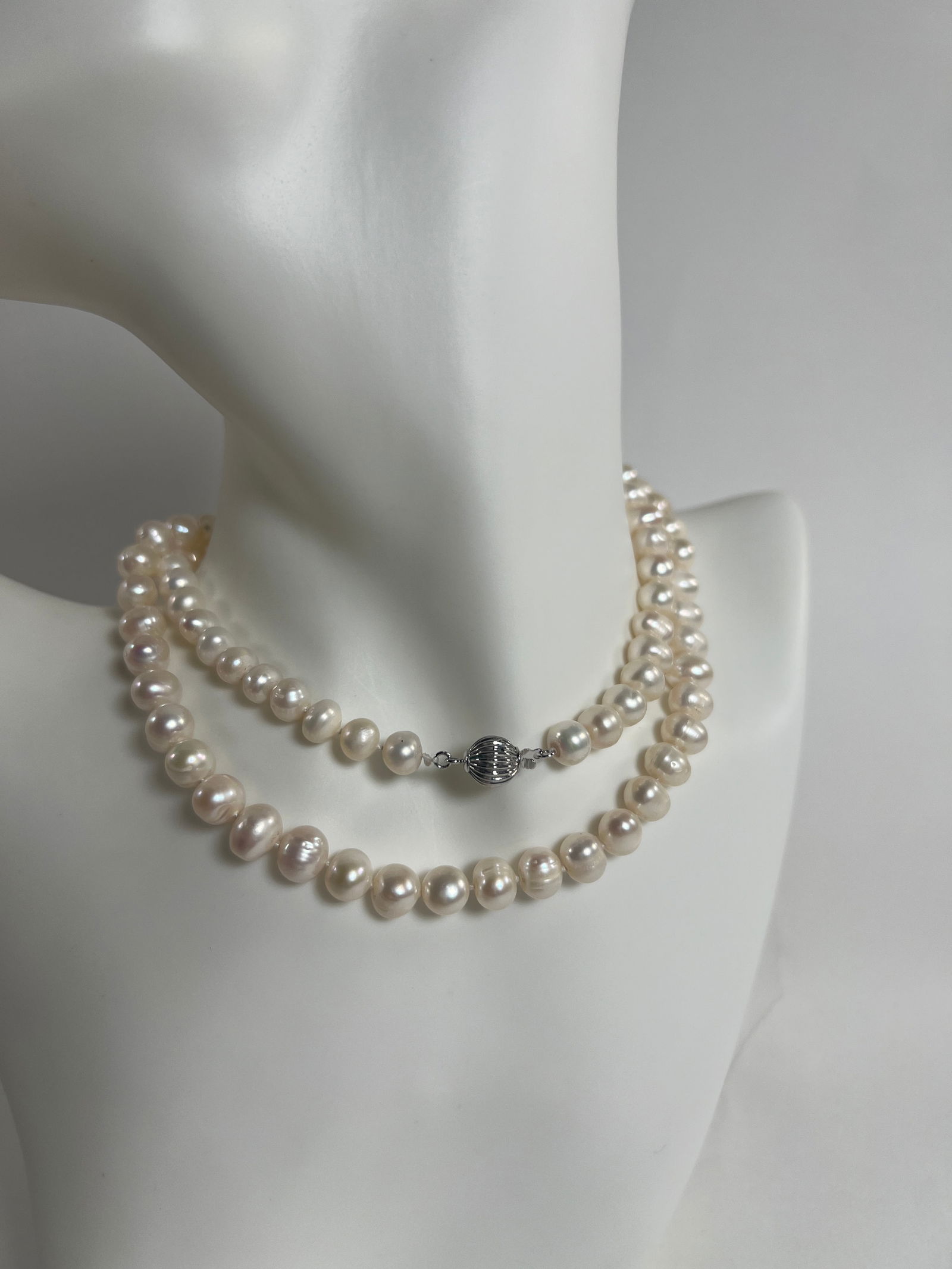 Pearl Necklace: Pearl necklace, weighing 1.7 oz and measuring 12.25 inches in length when closed. Silver tone clasp.