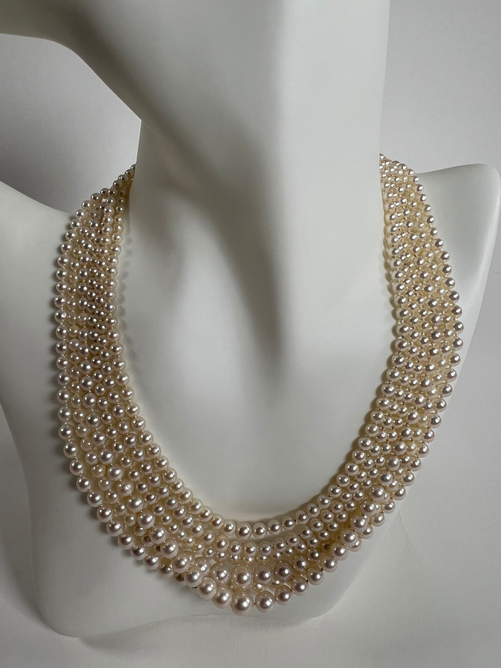 Multi-Strand Pearl Necklace: Elegant multi-strand pearl necklace. Features multiple strands of small, lustrous pearls. Silver tone clasp. Weight: 2.1 oz.