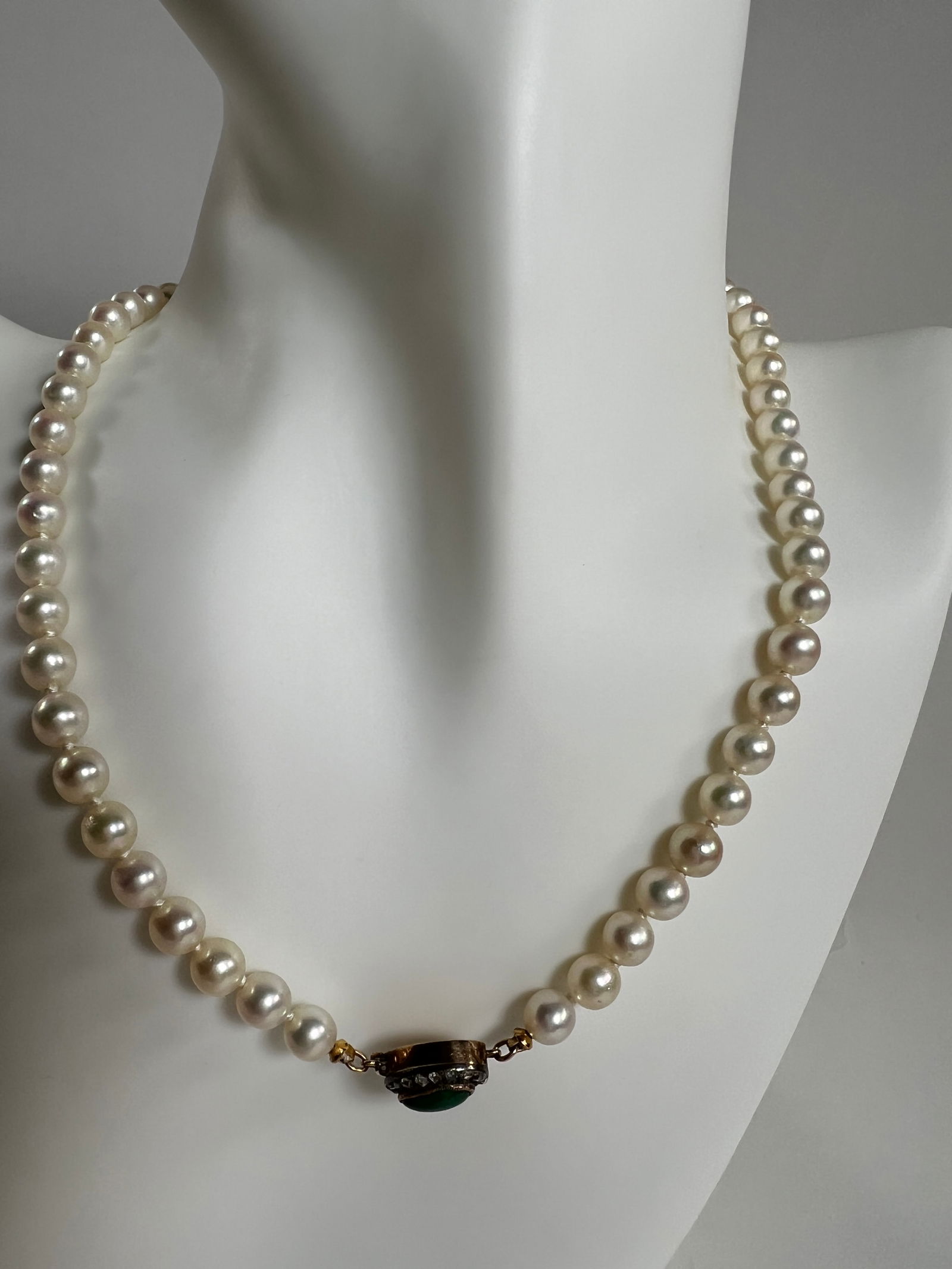 Vintage Pearl Necklace with Jade Clasp: Vintage pearl necklace featuring a jade clasp. The necklace weighs 0.8 oz and measures 7 inches in length when closed.