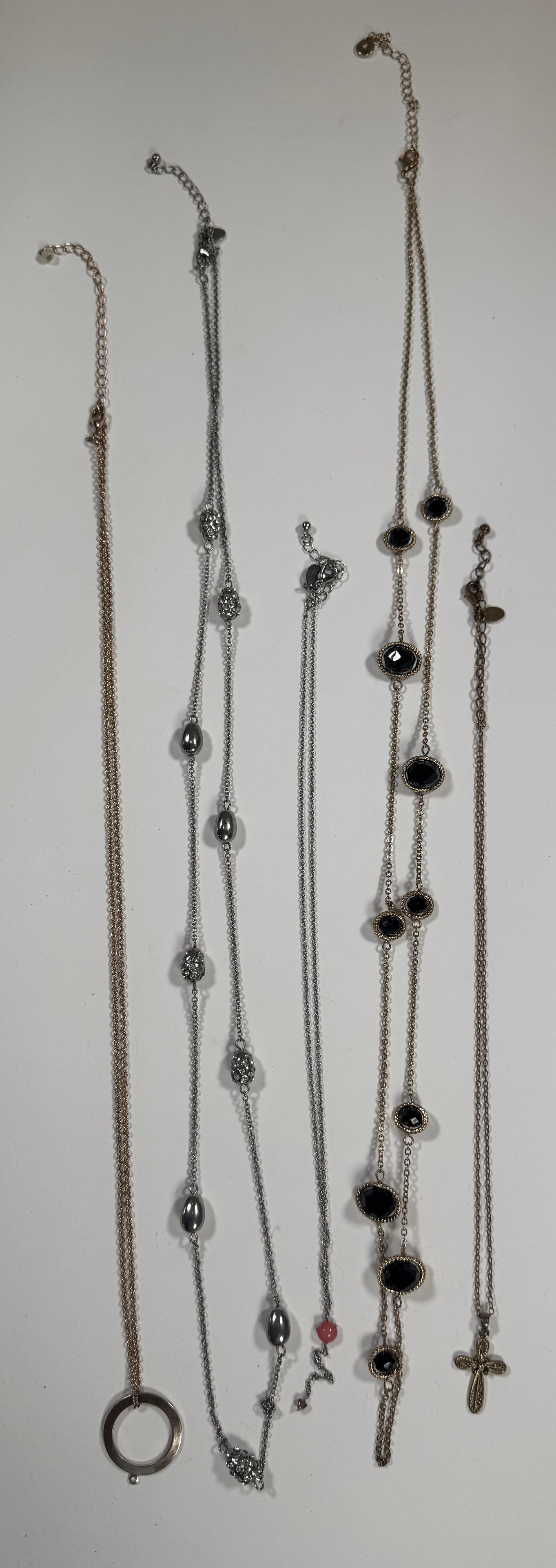 Group of Costume Necklaces: Collection of five costume necklaces. Includes beaded, pendant, and chain styles. Longest necklace measures approximately 22.25 inches when closed. Total weight: 2.2 oz.