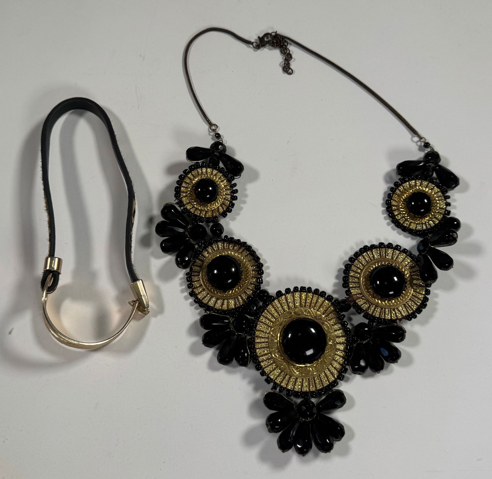Black & Gold Tone Necklace and Choker Set: Includes a black and gold tone floral design necklace and a black choker with gold tone hardware. Necklace is approximately 15 inches long and weighs 5.8 oz.