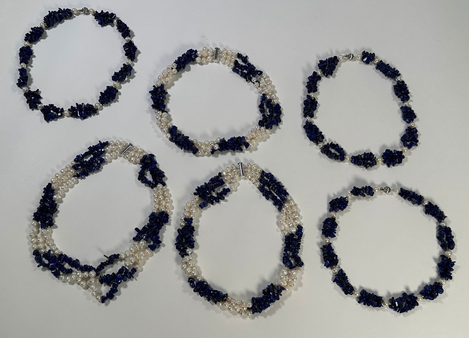 Lapis Lazuli & Pearl Necklace Assortment: Collection of 6 necklaces featuring lapis lazuli chips and cultured pearls. Includes 13 karat gold plated beads. The longest necklace measures approximately 8.5 inches. Variety of designs and lengths.