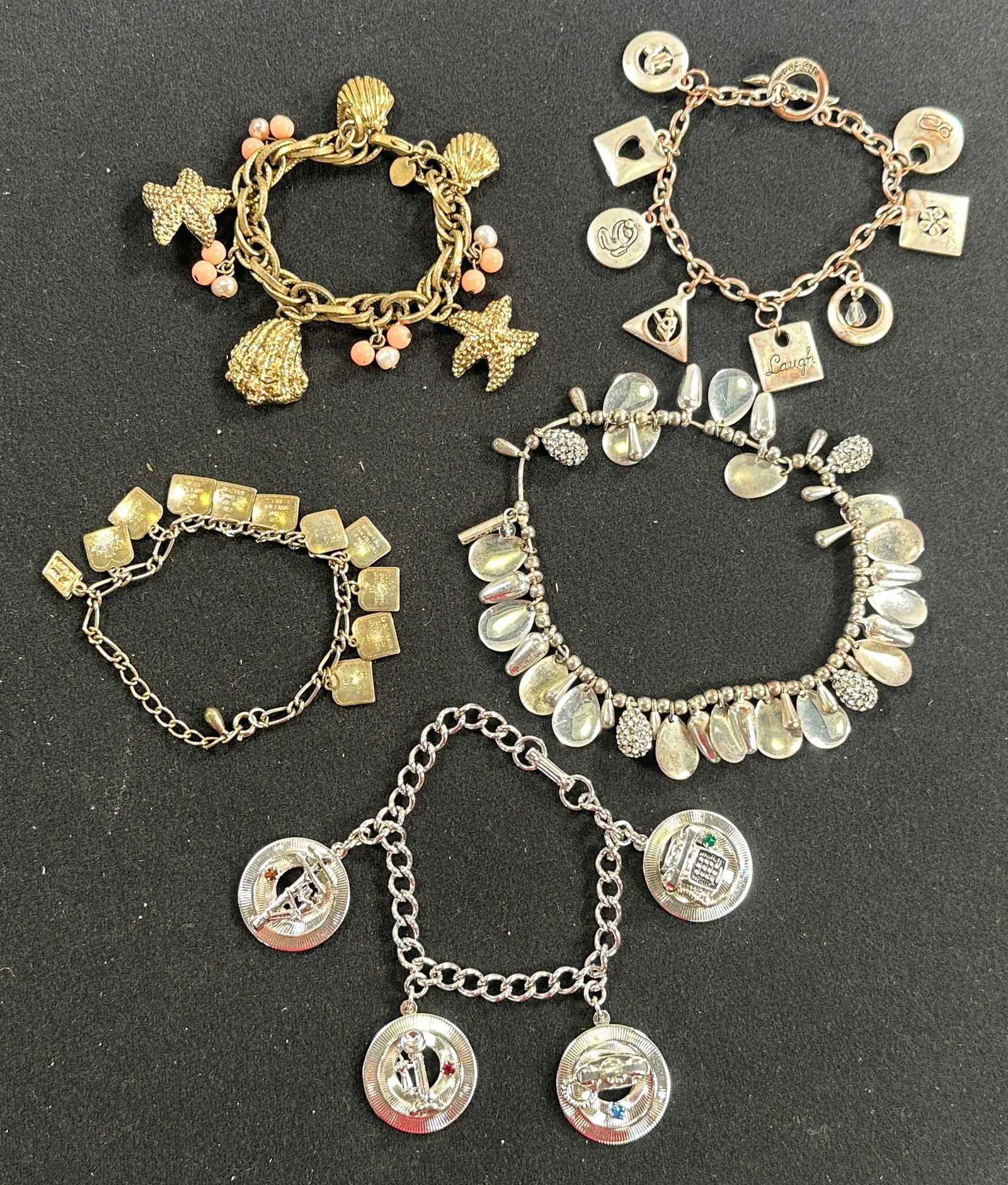 Group of Five Costume Charm Bracelets: Group of five costume charm bracelets. Weight: 6.6 oz. Largest bracelet measures 4 inches when closed. Includes bracelets with various charms and beadwork.