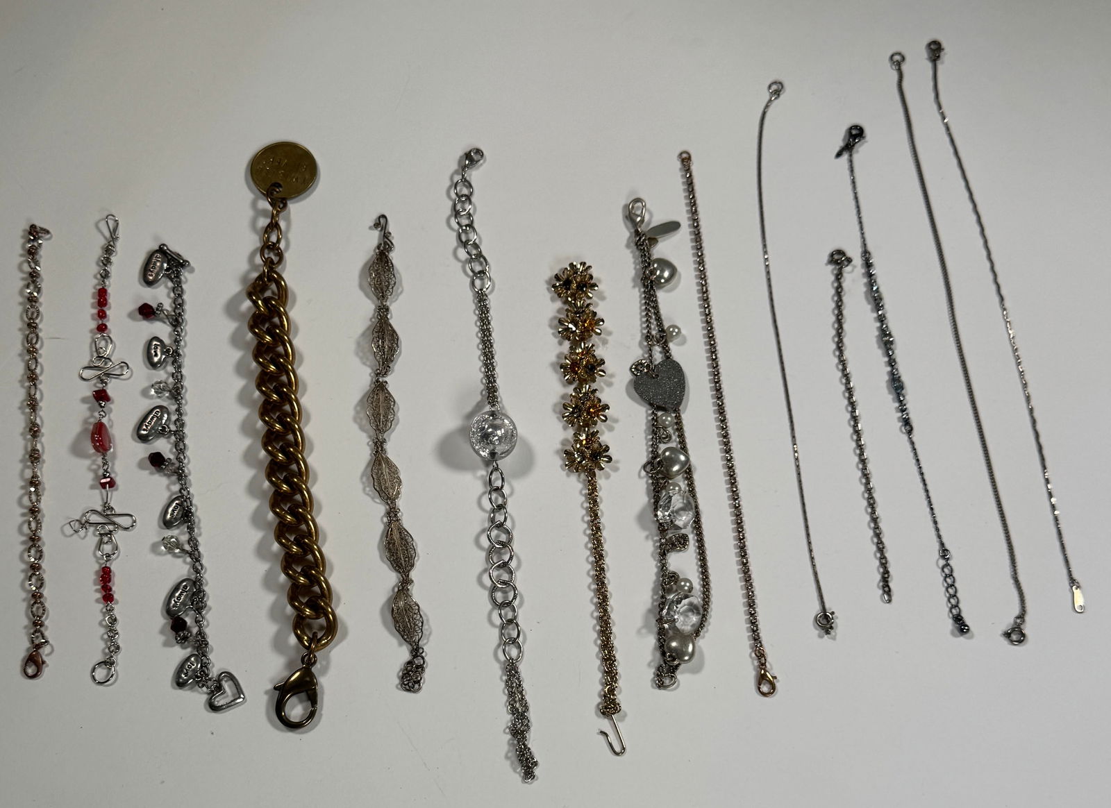 Group of Costume Bracelets: Collection of costume bracelets in various styles and metal tones. Weight: 5.8 oz.