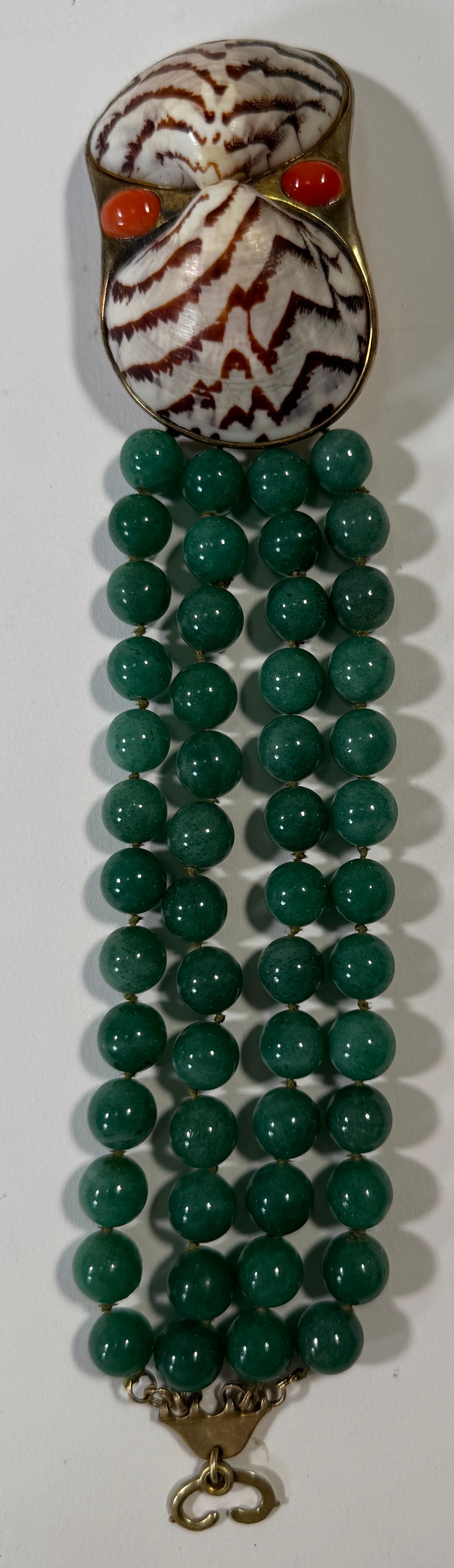 Vintage Shell, Coral & Green Bead Bracelet: Vintage bracelet featuring a shell and coral centerpiece with green bead strands. Sterling silver clasp. Measures approximately 8.5 inches long and weighs 4.3 oz.