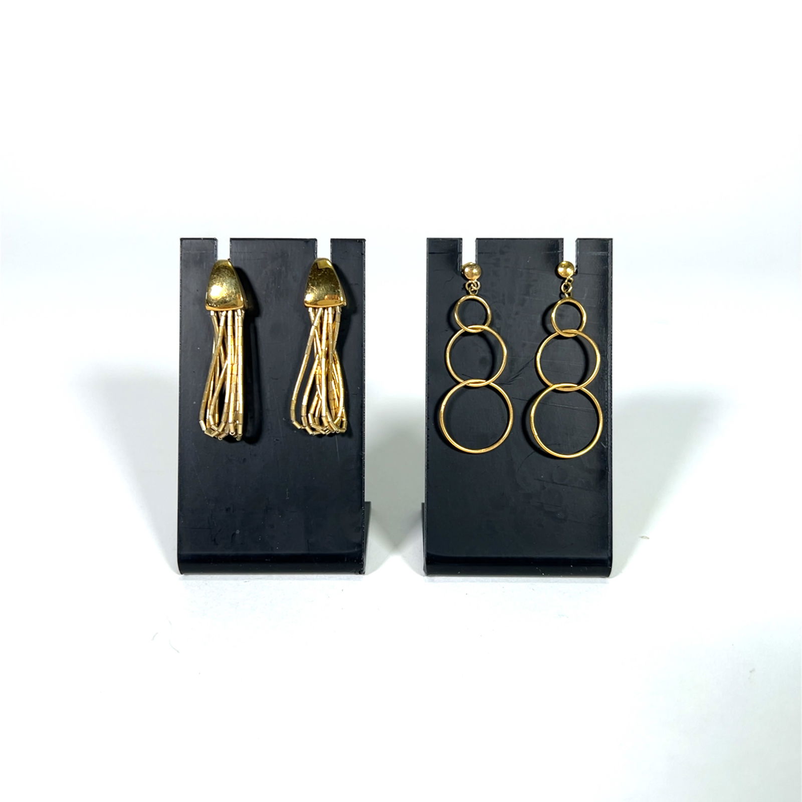 Two Pairs of Fashion Earrings: Two pairs of earrings. One pair features gold-tone metal fringe. The other pair is gold-tone metal with three graduated circles.