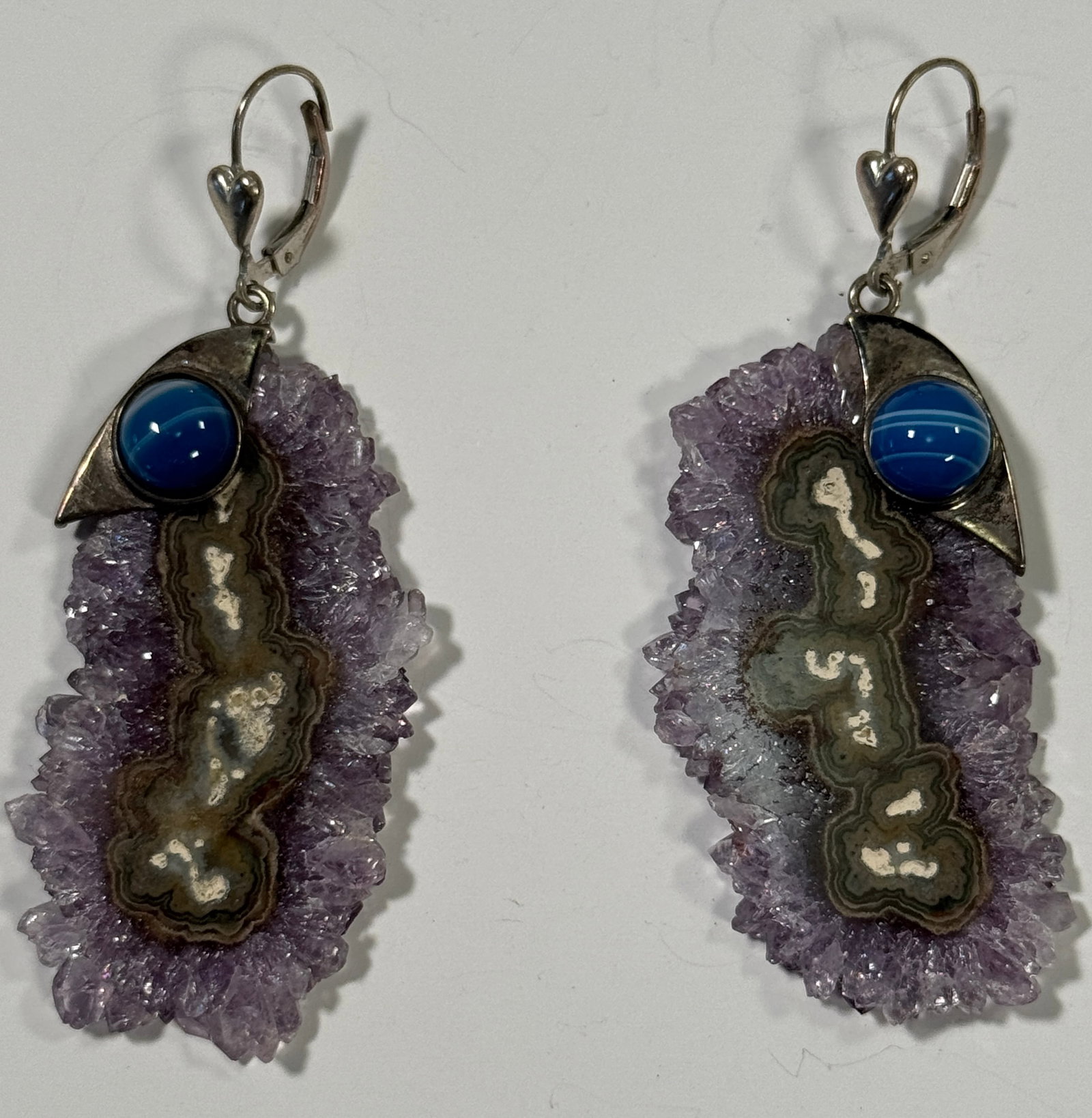 Amethyst & Blue Agate Sterling Silver Earrings: Pair of sterling silver earrings featuring amethyst druzy slices and blue agate cabochons. Lever-back closures. Stamped '925'.Length : 2 3/4"
