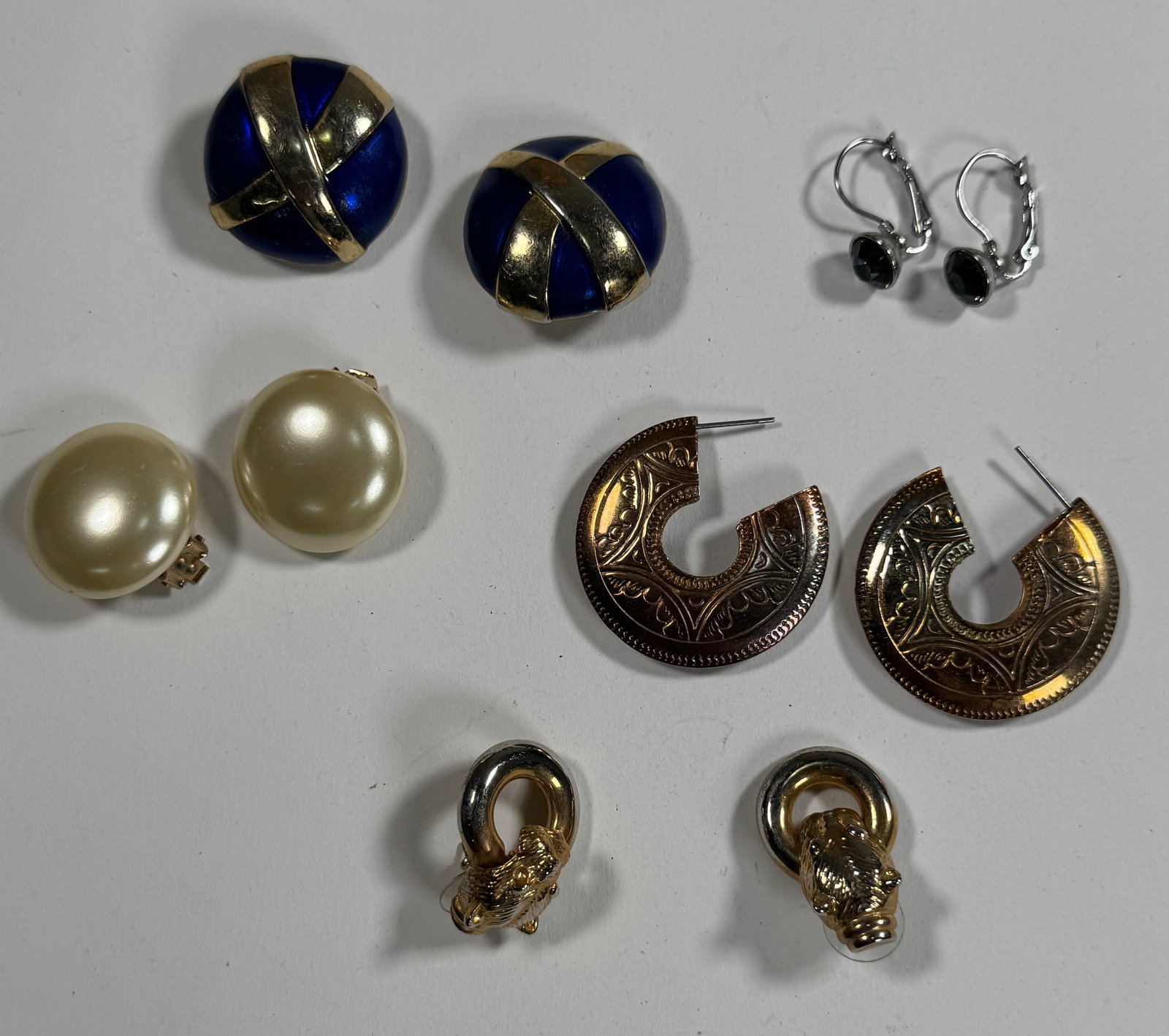 Group of Vintage Earrings: A collection of vintage earrings, including clip-on and pierced styles. Materials include metal, faux pearl, and possibly enamel. Largest earring measures approximately 1.5 inches. Total weight: 73.7g
