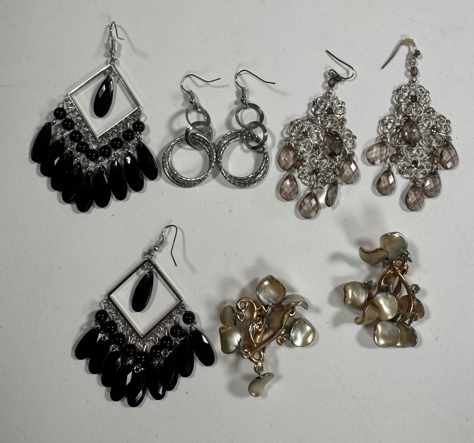 Group of Fashion Earrings - 4 Pairs: A collection of 4 pairs of fashion earrings. Includes drop earrings with black and clear beads, and circular designs. Largest pair measures approximately 3.5 inches. Total weight: 1.7 oz.